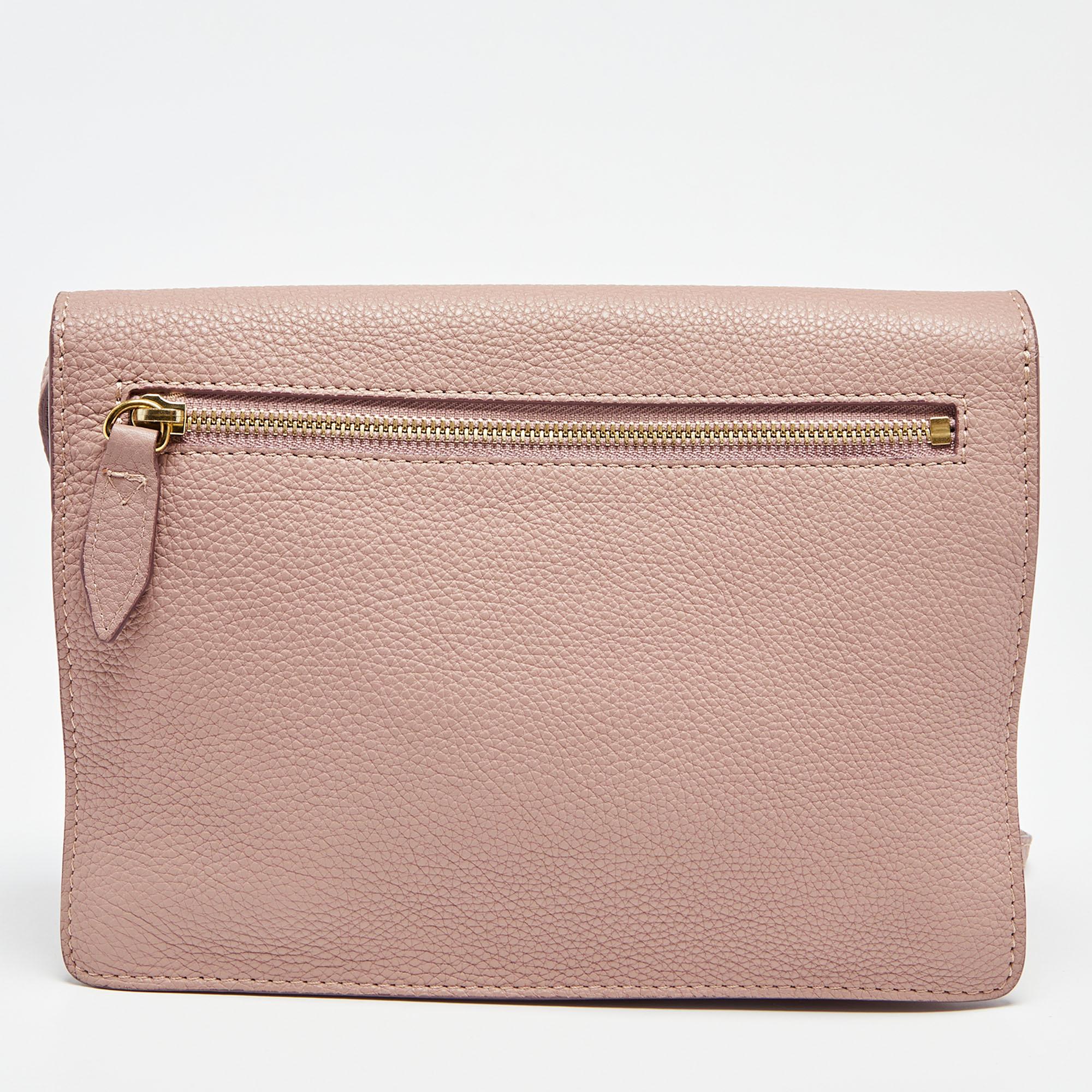 This Macken crossbody bag from Burberry is both elegant and fashionable. Crafted from pink House Check fabric and leather, this bag features a chain strap, gold-tone hardware, and a spacious fabric-lined interior. Make this stunning bag your