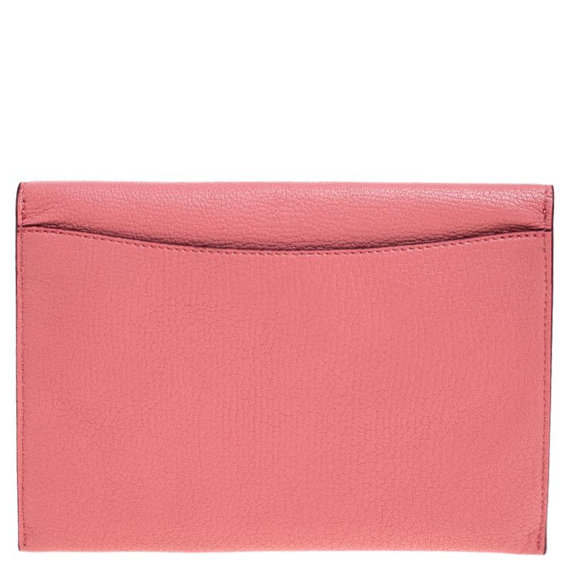 This Burberry clutch will be the perfect finishing touch to many of your gorgeous outfits. It is crafted from pink leather and designed with a flap that has a metal detail. Equipped with a leather interior, this clutch will be a handy style