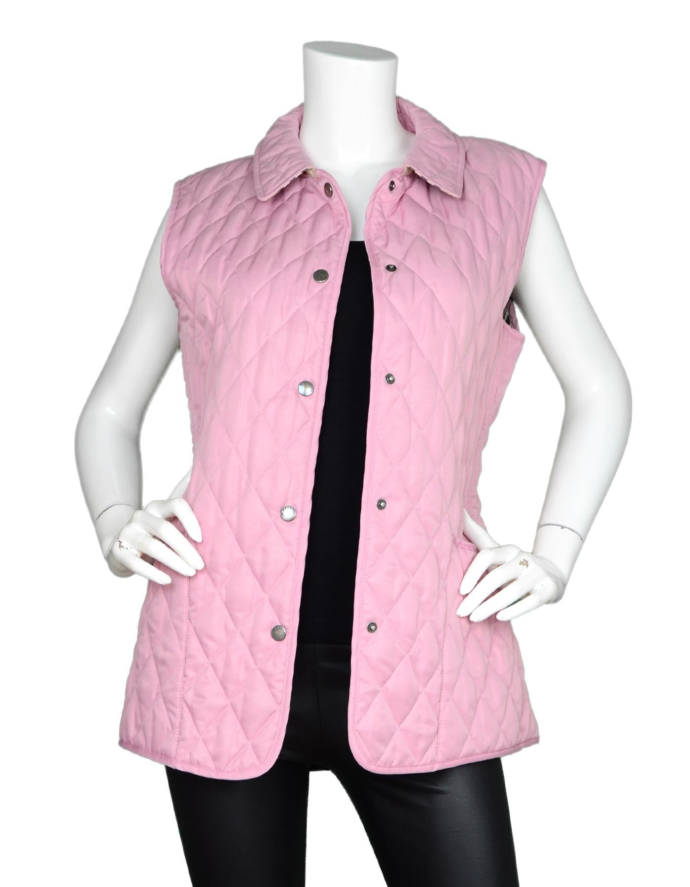 Burberry Pink Quilted Vest W/ Tartan/Plaid Interior Sz M

Made In: England
Color: Pink
Materials: 100% polyester
Lining: 50% cotton, 50% polyester 
Opening/Closure: Button front
Overall Condition: Excellent pre-owned condition with excpetion of some