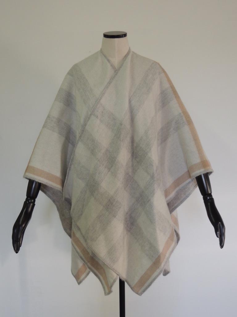 This is a Burberry wrap in a grey plaid, in 100% cashmere, luxurious and ultra soft. Made in Scotland.

This is in excellent, lightly-used condition.

The wrap measures 60 inches by 23 inches.
