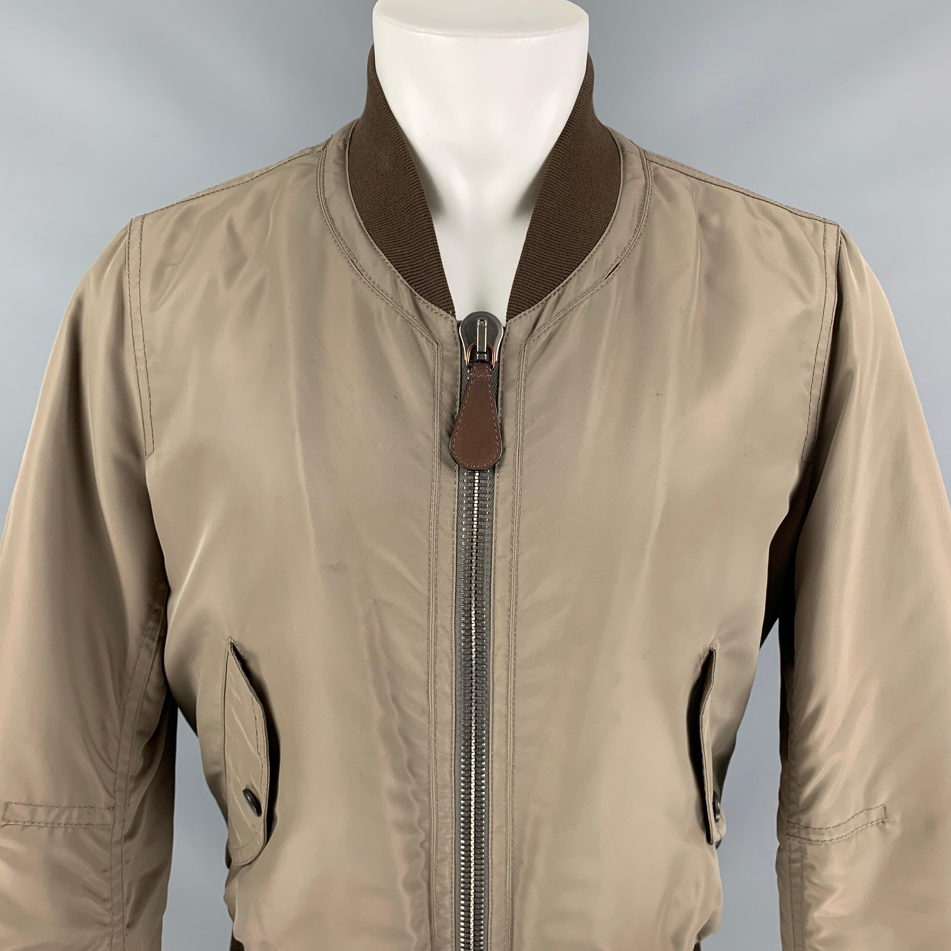 BURBERRY PRORSUM Men's taupe and brown bomber jacket with rib knit collar, dual flap pockets at sides, tonal quilted lining, dual interior seam pockets and zip closure at center front.Good Pre-Owned Condition.  

Marked:   IT 46Shoulder: 17.5 inches