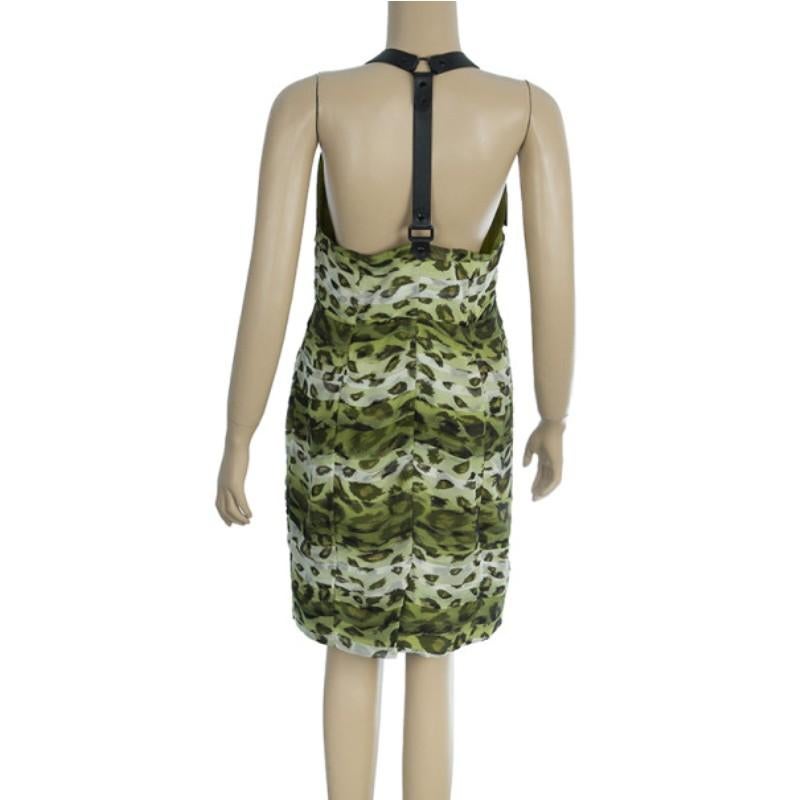 Grace your cocktail parties with this Burberry halter dress. Part of the Prorsum label, its leopard-printed silk design in cream, green, and black give it an exotic finish with a leather trim on the shoulder straps and across the center with its