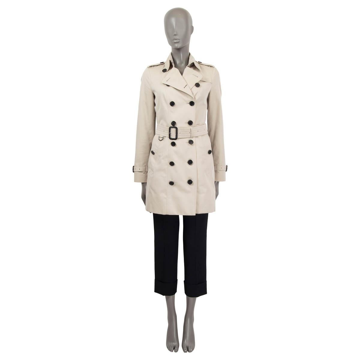 100% authentic Burberry 'The Sandringham' mid-length coat in light sand cotton (100%). Features epaulettes on the shoulders and the cuffs. Has a slit at the back and a detachable belt. Opens with one hook and buttons on the front. Lined in classic