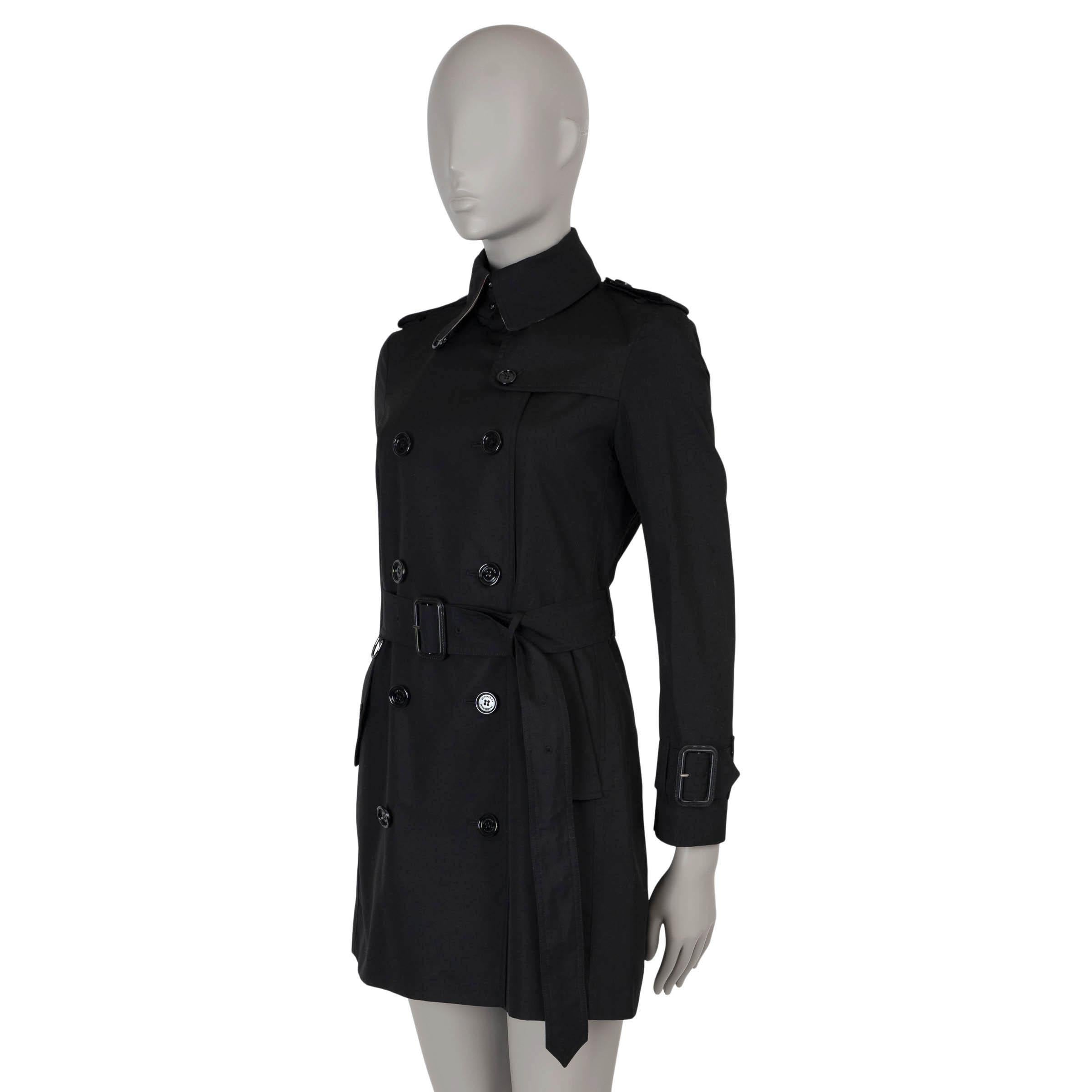 This 100% authentic Burberry Prorsum heritage trench coat is crafted from black gabardine, made of polyester (65%) and cotton (35%). It features iconic trench details such as epaulettes, a storm flap, back yoke, wrist belts, and buttoned flap