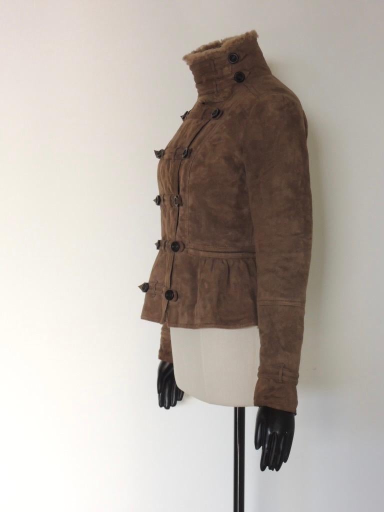 Heavy, luxurious shearling jacket by Burberry Prorsum in a light brown color. Button front, button and zipper closures at sleeve ends. 

The jacket is tagged size 42.

The jacket is in good pre-owned condition. There are no holes or tears in the