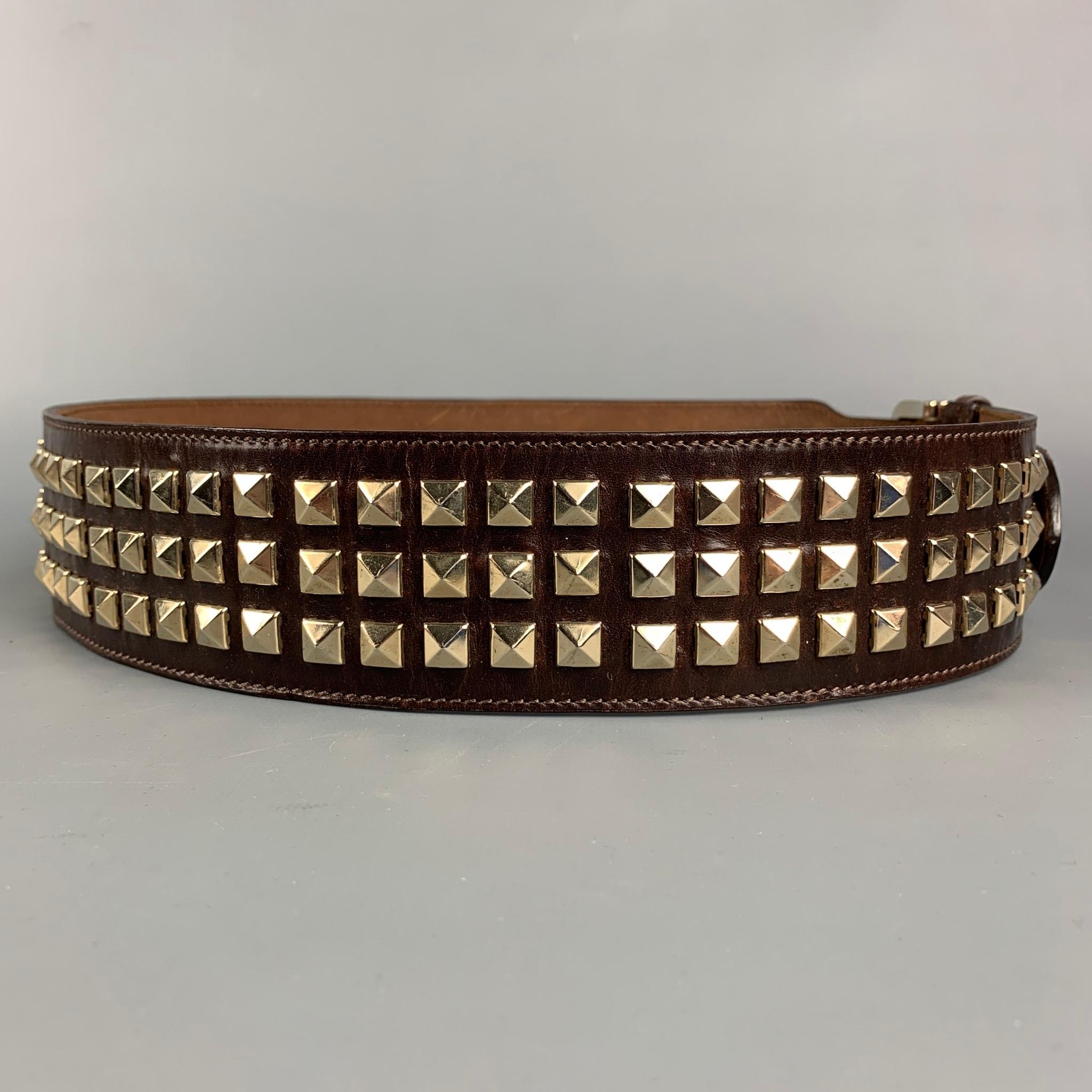 BURBERRY PRORSUM Fall 2008 belt comes in a brown studded leather featuring a gold tone buckle. Made in Italy. 

Very Good Pre-Owned Condition.
Marked: No size marked

Length: 41 in.
Width: 2.25 in.
Fits: 34 in. - 36 in.
Buckle: 2 in. 