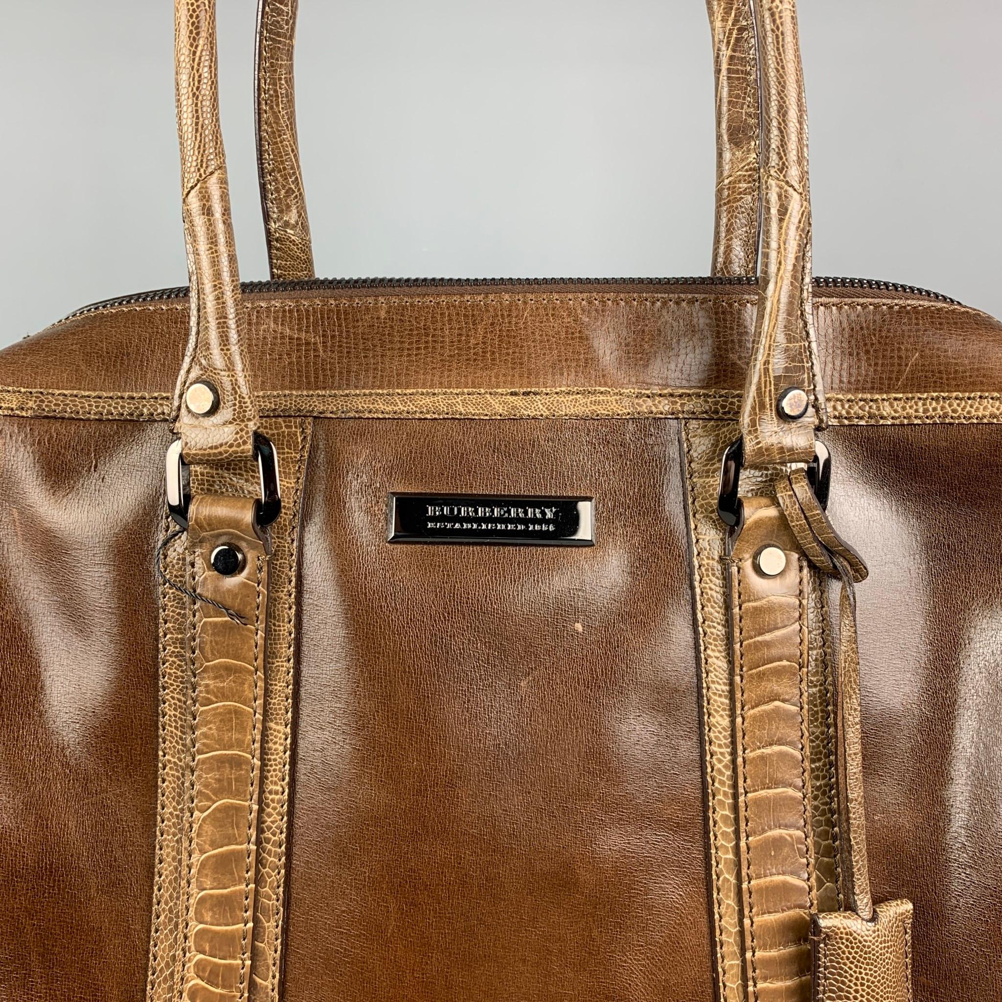 Early Burberry Prorsum Fall 2008 Brown Leather Tote by Christopher Bailey featuring mocha leather, gunmetal hardware, ostrich trim, dual shoulder straps. Interior features a jacquard lining and three interior pockets. Zip Closure at the top of the