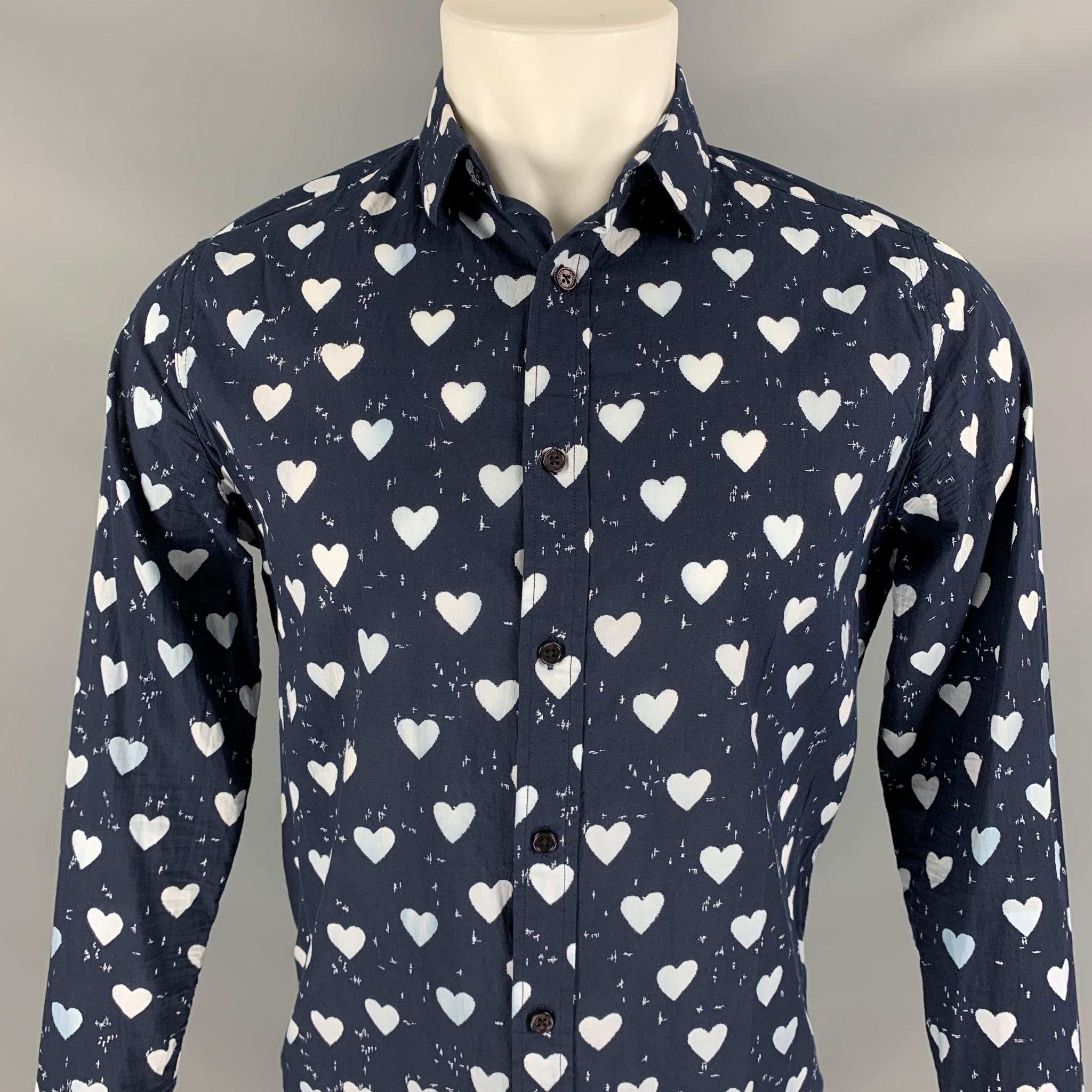BURBERRY PRORSUM Pre-Fall 2013 long sleeve shirt comes in a navy & white heart print material featuring a spread collar and a button up closure. 

Very Good Pre-Owned Condition.
Marked: 46

Measurements:

Shoulder: 17 in.
Chest: 40 in.
Sleeve: 25