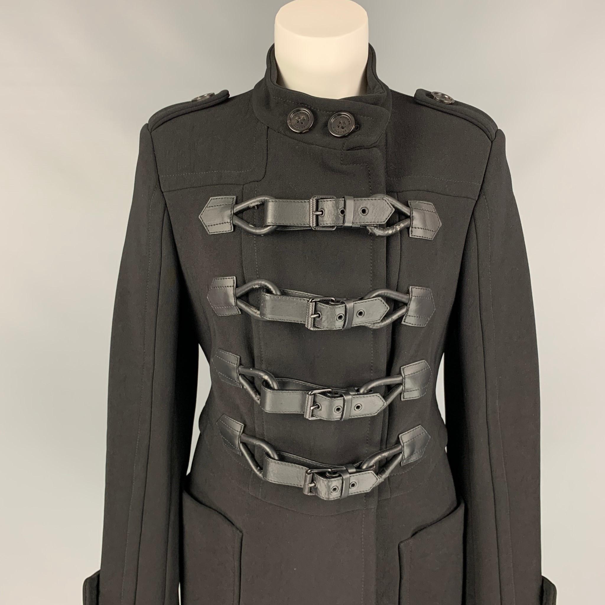 BURBERRY PRORSUM coat comes in a black nylon / cotton with a full liner featuring a military style, back strap detail, epaulettes, patch pockets, and a duffle closure. Made in Italy. 

Very Good Pre-Owned Condition. Light wear at closure.
Marked: