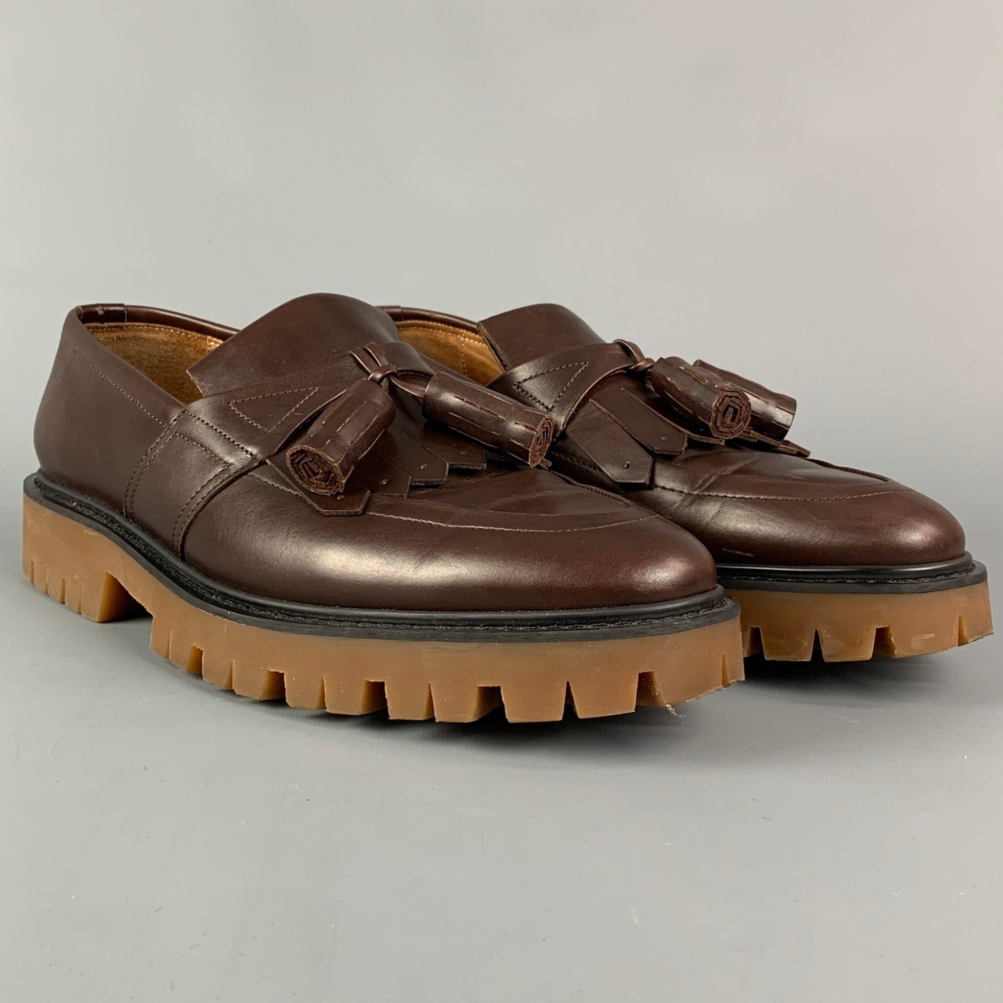 BURBERRY PRORSUM 'Cowall Loafers' shoes comes in a brown leather featuring a front tassel design, slip on, and a chunky sole. Includes box. 

Very Good Pre-Owned Condition.
Marked: 45

Outsole: 13.25 in. x 4.5 in.