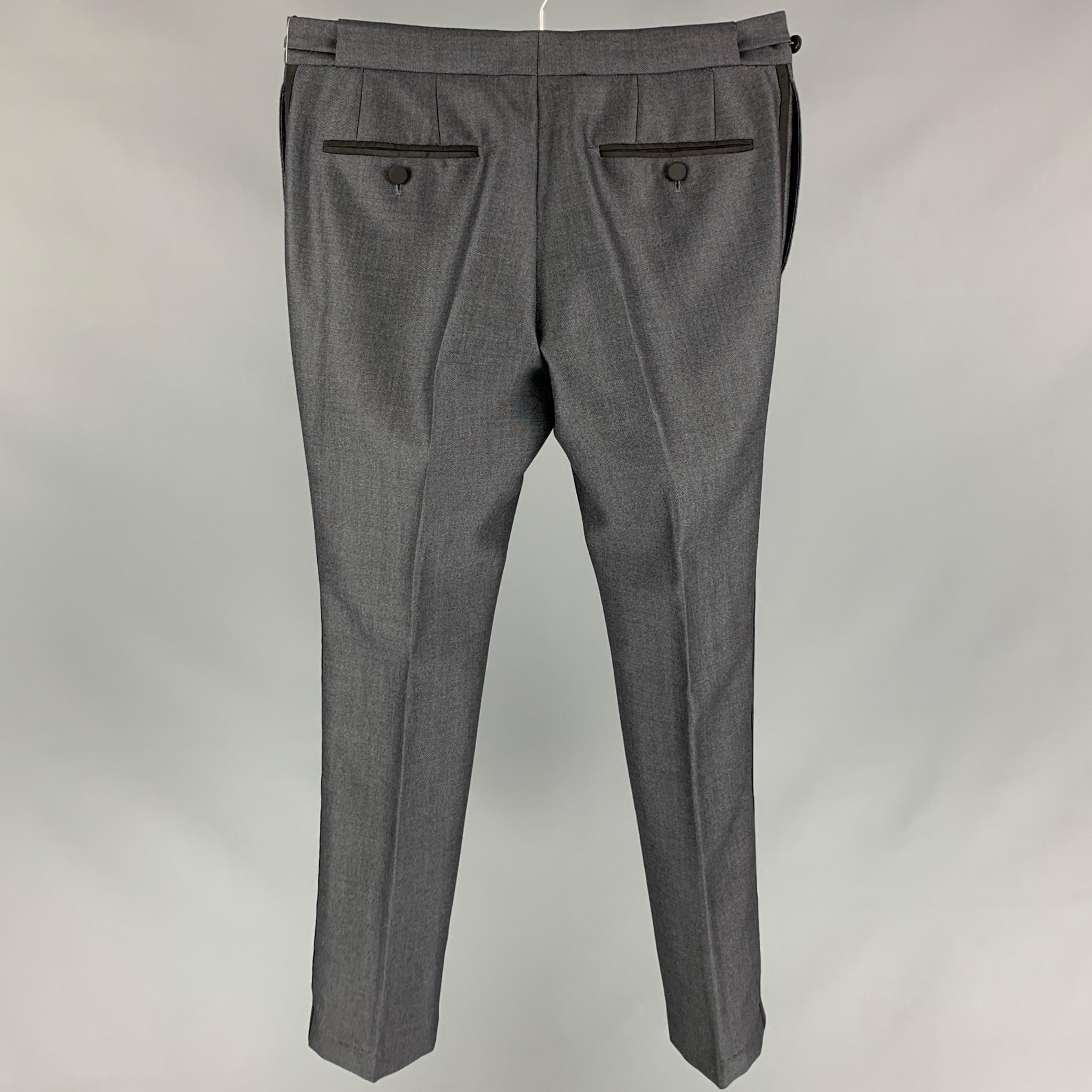 BURBERRY PRORSUM tuxedo dress pants comes in a slate grey wool with a silk stripe featuring a slim fit, side tabs, front tab, and a zip fly closure. Made in Italy. 

Very Good Pre-Owned Condition.
Marked: 48

Measurements:

Waist: 32 in.
Rise: 10