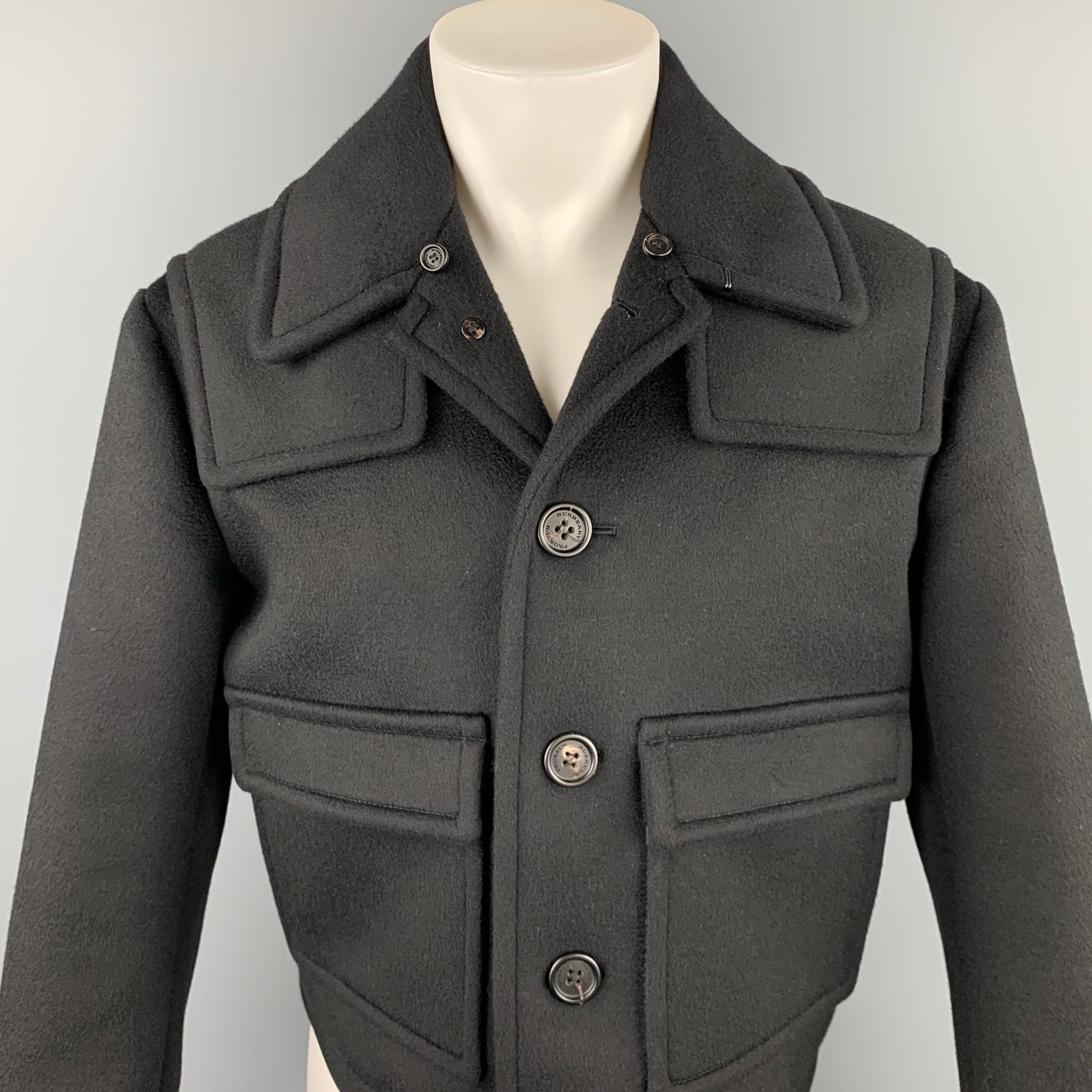 BURBERRY PRORSUM jacket comes in a black cashmere blend with a full monogram print liner featuring a cropped style, patch pockets, and a buttoned closure. Made in Italy.

Excellent Pre-Owned Condition.
Marked: IT 48

Measurements:

Shoulder: 20