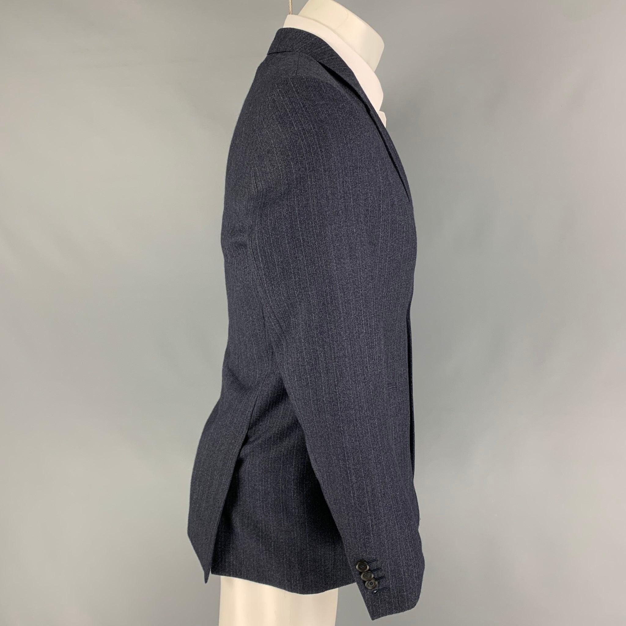 BURBERRY PRORSUM sport coat comes in a navy stripe wool with a full liner featuring a notch lapel, flap pockets, double back vent, and a double button closure.
Very Good
Pre-Owned Condition. 

Marked:   50 

Measurements: 
 
Shoulder: 17 inches 