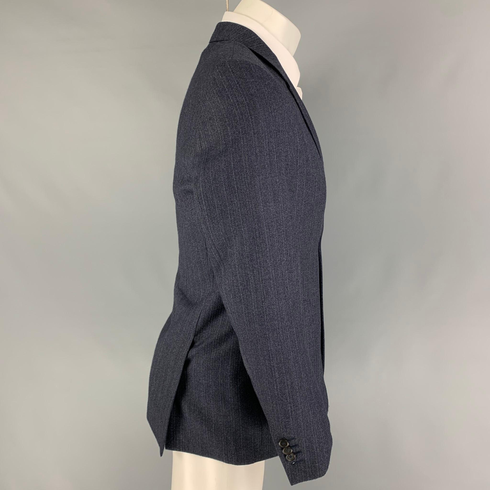 BURBERRY PRORSUM sport coat comes in a navy stripe wool with a full liner featuring a notch lapel, flap pockets, double back vent, and a double button closure. 

Very Good Pre-Owned Condition.
Marked: 50

Measurements:

Shoulder: 17 in.
Chest: 40