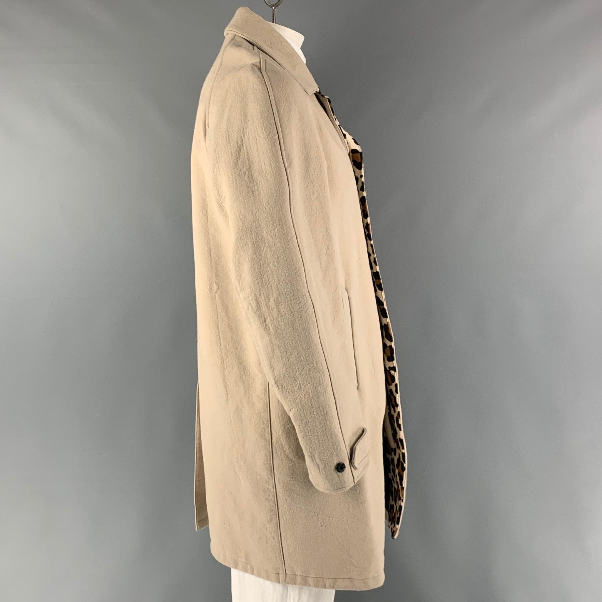 BURBERRY PRORSUM Long Coat comes in a beige canvas woven material with a full liner featuring a real dyed animal print hair calf as an inside detail, snap buttons closure, hidden placket,
 single breasted, and a raglan style. Made in Italy.Very Good