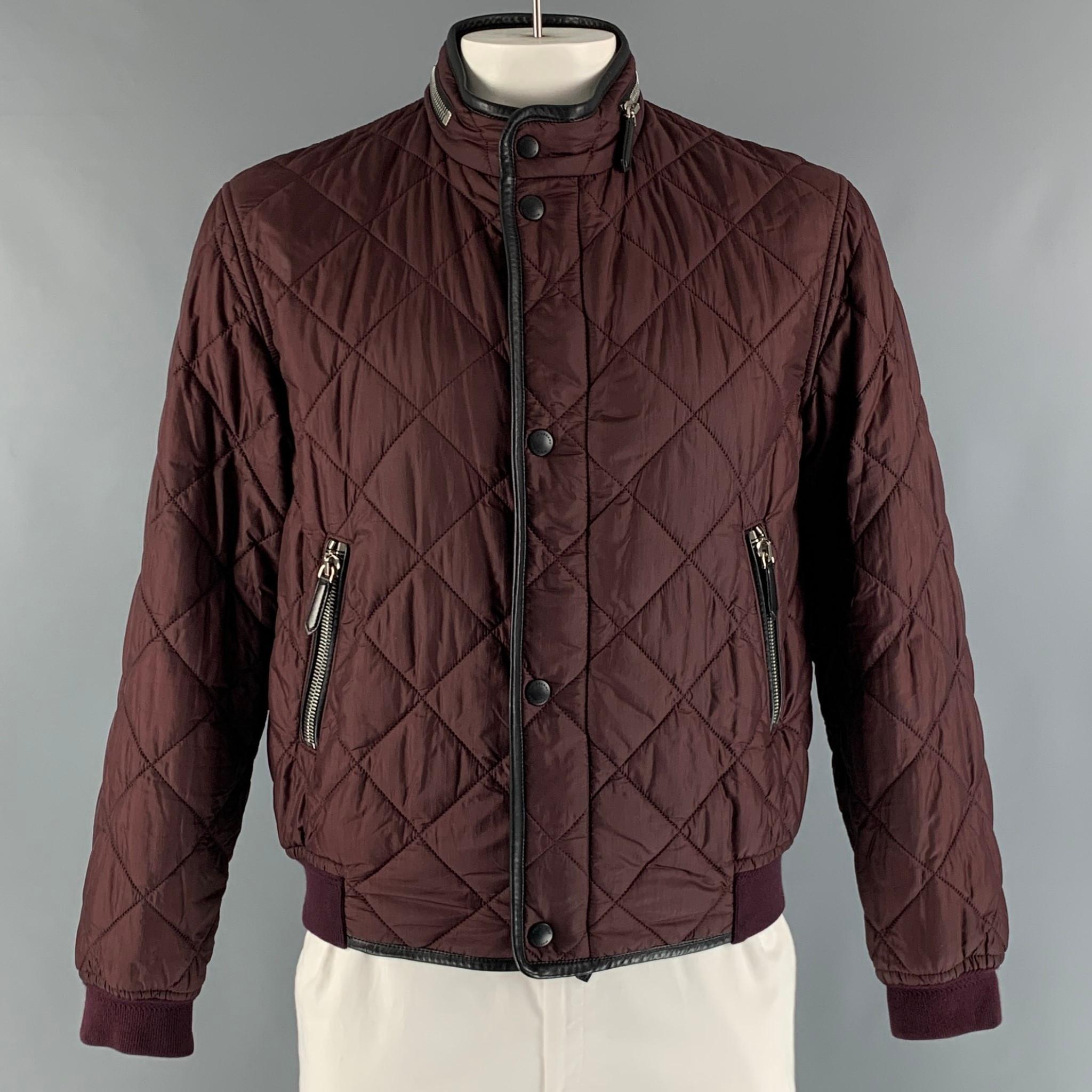 Burberry Prorsum Spring 2016 Puffer Jacket by Christopher Bailey comes in burgundy nylon woven material features a deconstructed lining, leather trim embellishment, built -in hood at collar,  zip pockets & zip closure. Made in Italy.

Excellent