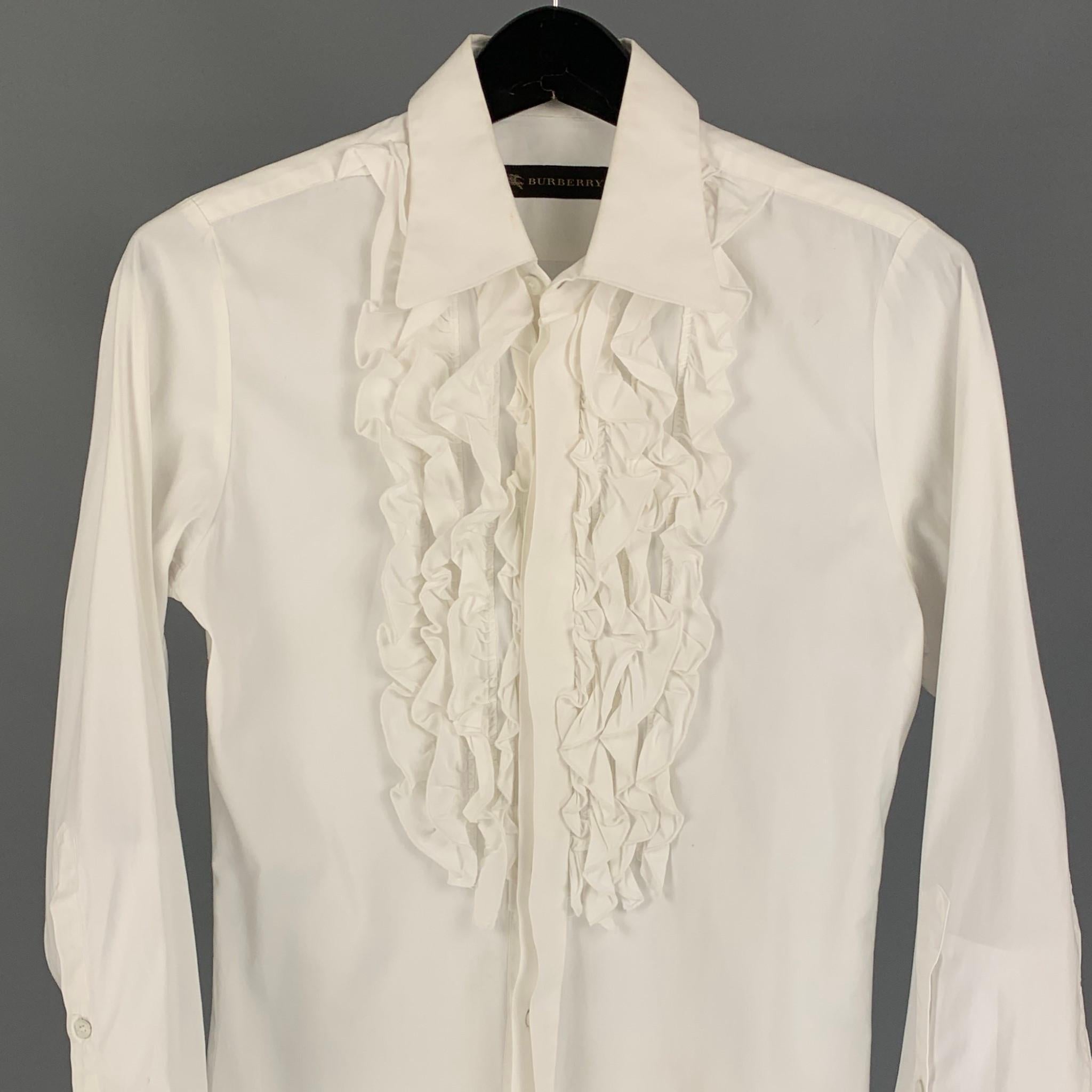 BURBERRY PRORSUM  tuxedo long sleeve shirt comes in a white material with a front ruffle design featuring a pointed collar and a hidden placket closure. 

Good Pre-Owned Condition. Minor stain at back. Fabric tag removed.
Marked: