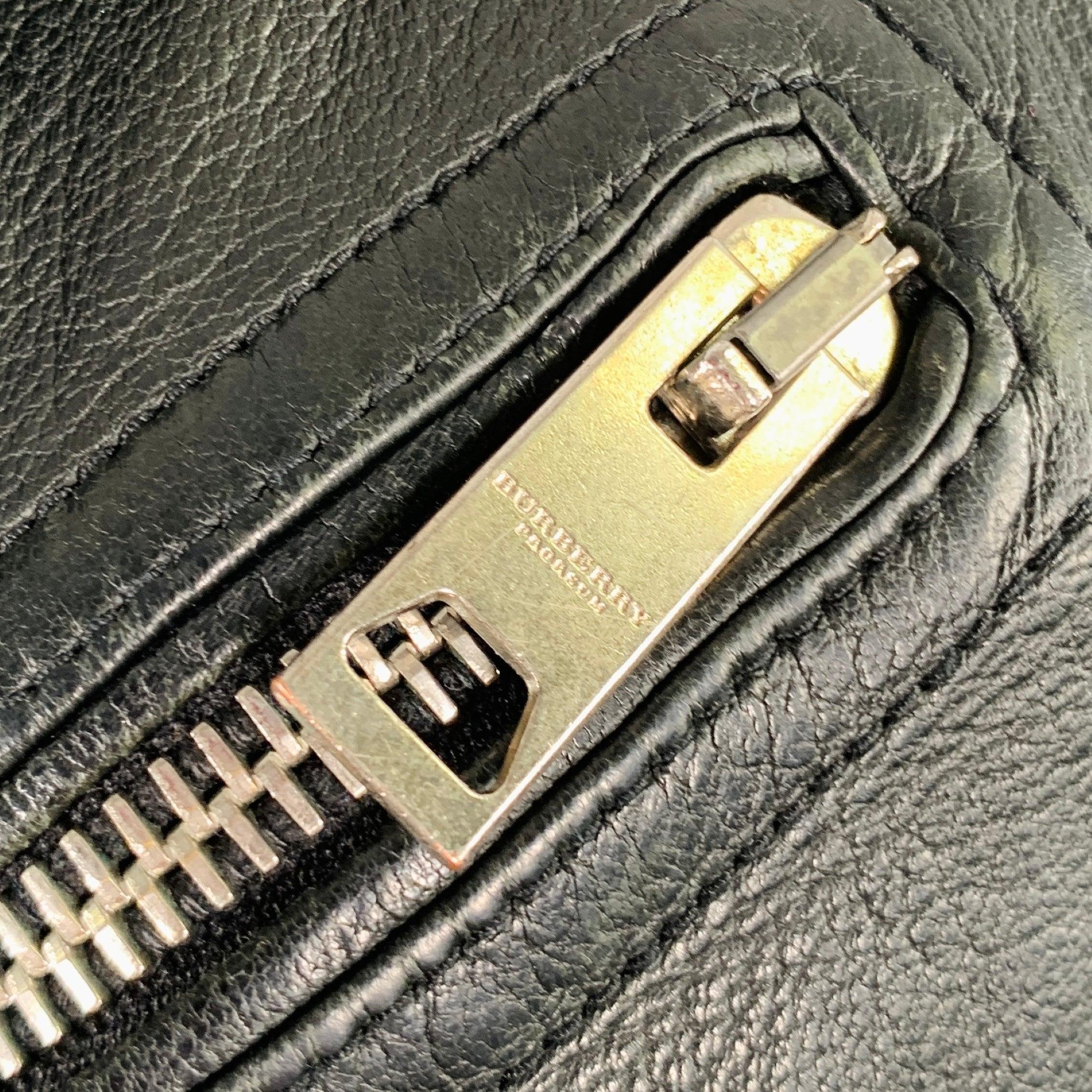 BURBERRY PRORSUM Spring 2011 iconic vest in a black leather fabric featuring a biker style, distressed design, and silver tone metal zipper pockets and closure. Made in Italy.Very Good Pre-Owned Condition. Minor signs of wear. 
 
 Marked: 
 48 
 
