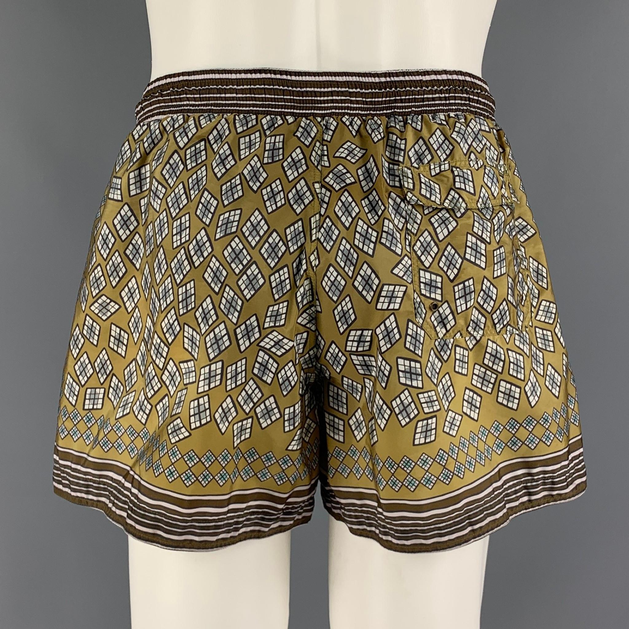 Burberry Prorsum Spring 2013 Swim Shorts / Trunks by Christopher Bailey. Drawstring waist, net mesh lining, internal pouch. Geometric pattern of Olive and Brown hues, suggests a throwback to the pallid tones and impressionistic patterns of the