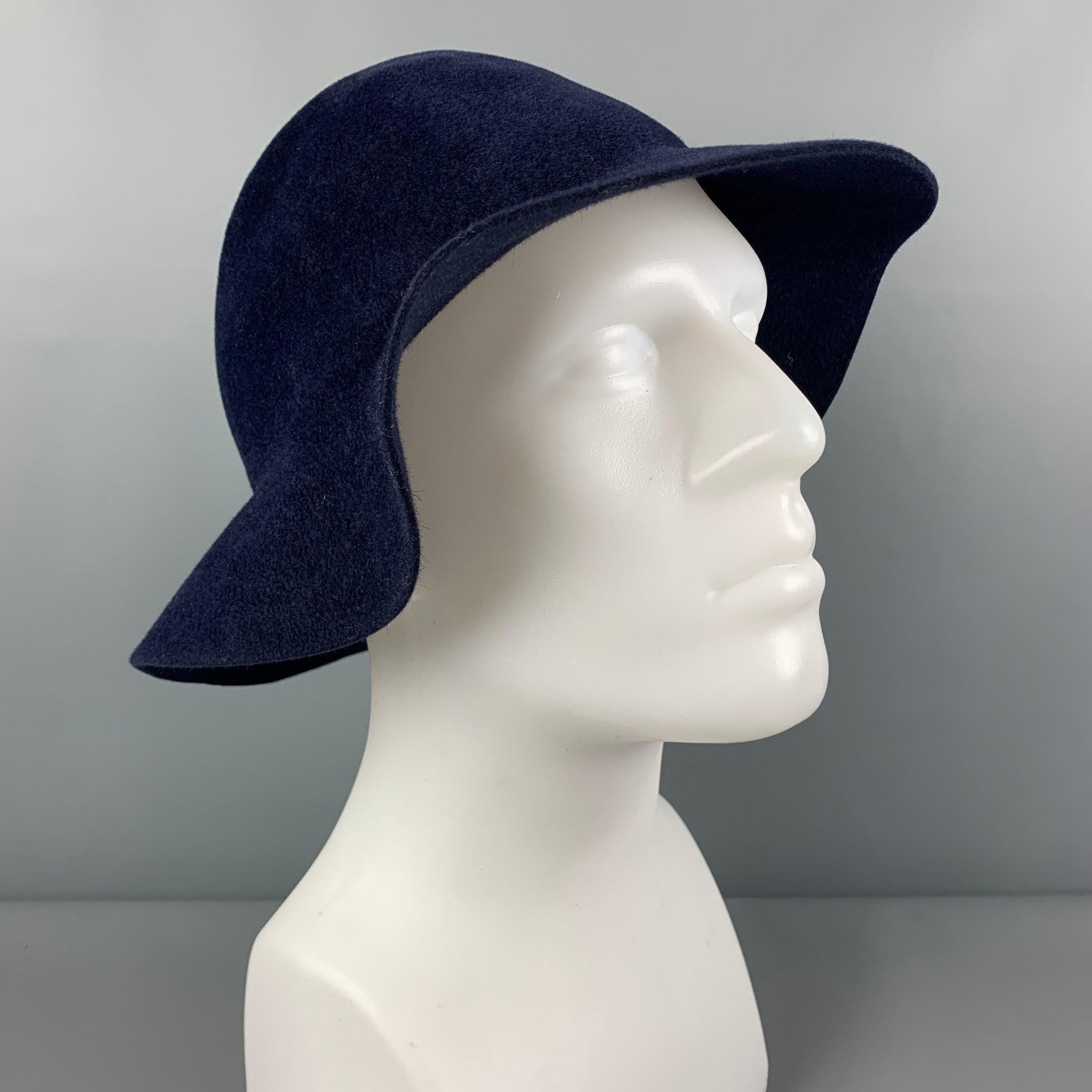 BURBERRY PRORSUM by Christopher Bailey Spring 2015 hat comes in a navy blue rabbit fur felt and a ribbon trim. Made in Italy.
Very Good
Pre-Owned Condition. 

Marked:   L 

Measurements: 
  Opening: 22.5 inches Brim: 22.5 inches Height: 5 inches 
 