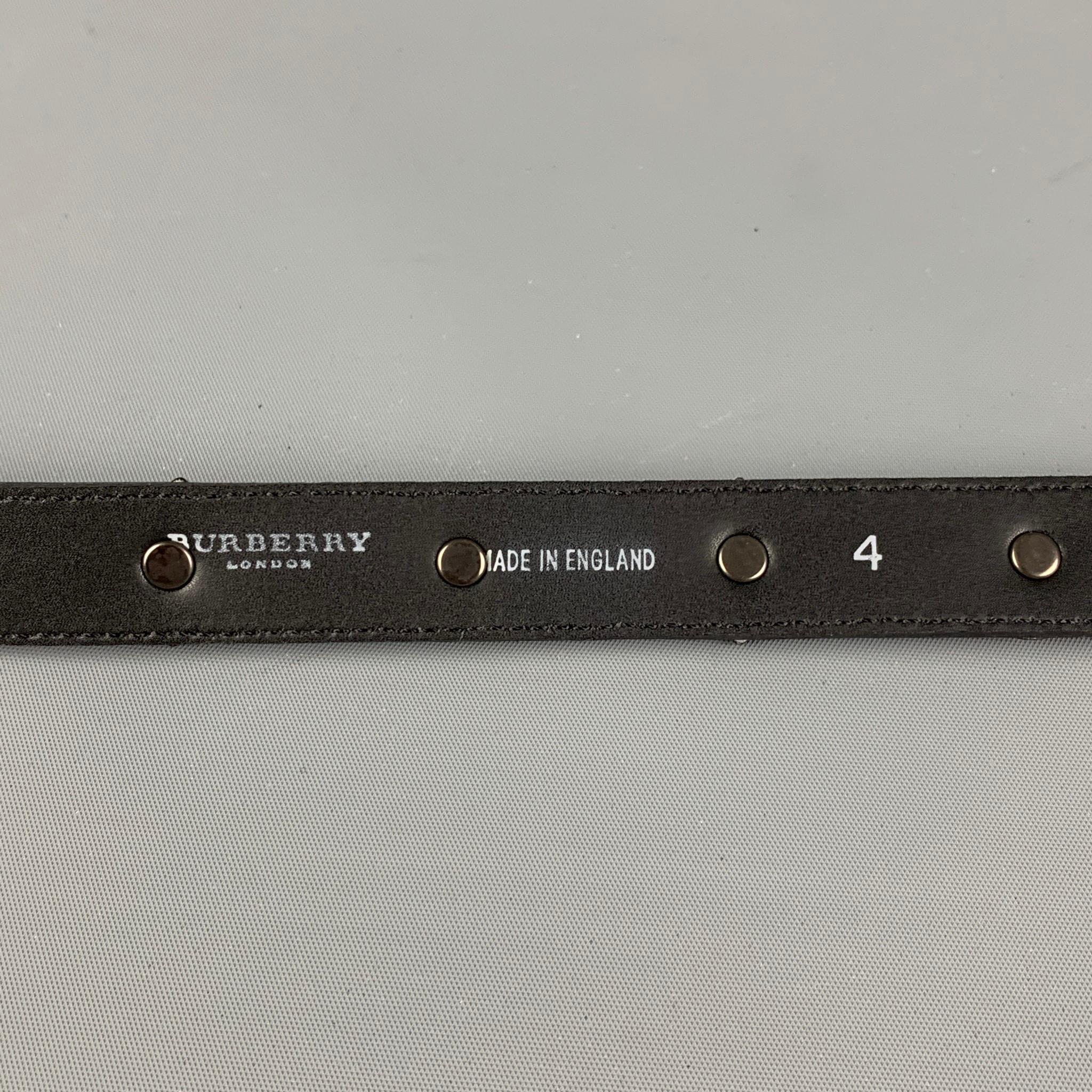 BURBERRY PRORSUM SS 08 'Warrior Collection' belt comes in a black leather featuring embellished details and a buckle closure. Made in England.

Very Good Pre-Owned Condition.
Marked: 4

Length: 36.5 in.
Width: 1 in.
Fits: 33.5 in. 35.5 in.
Buckle: 1