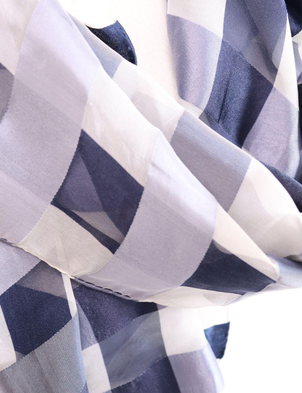 Add timeless sophistication to your wardrobe with this Burberry Navy Check Silk Scarf. Featuring a modern take on the brand’s signature check pattern in deep navy and soft neutral tones, this lightweight silk scarf offers effortless elegance. Its