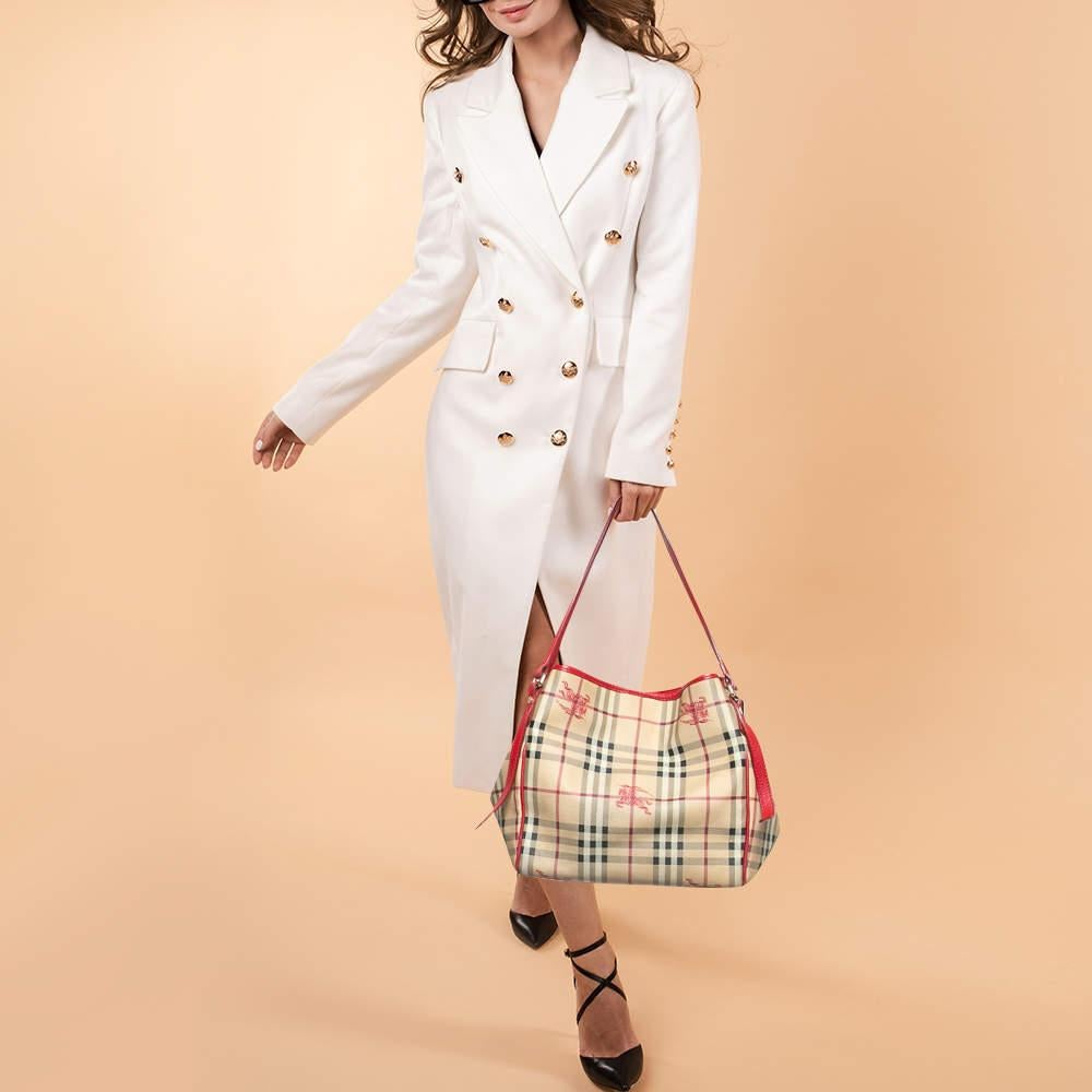 This Canterbury tote from Burberry is crafted from Haymarket Check canvas and enhanced with red leather. It comes with dual flat handles  protective metal feet  and a spacious canvas lined interior that can hold all your daily necessities. Simple in