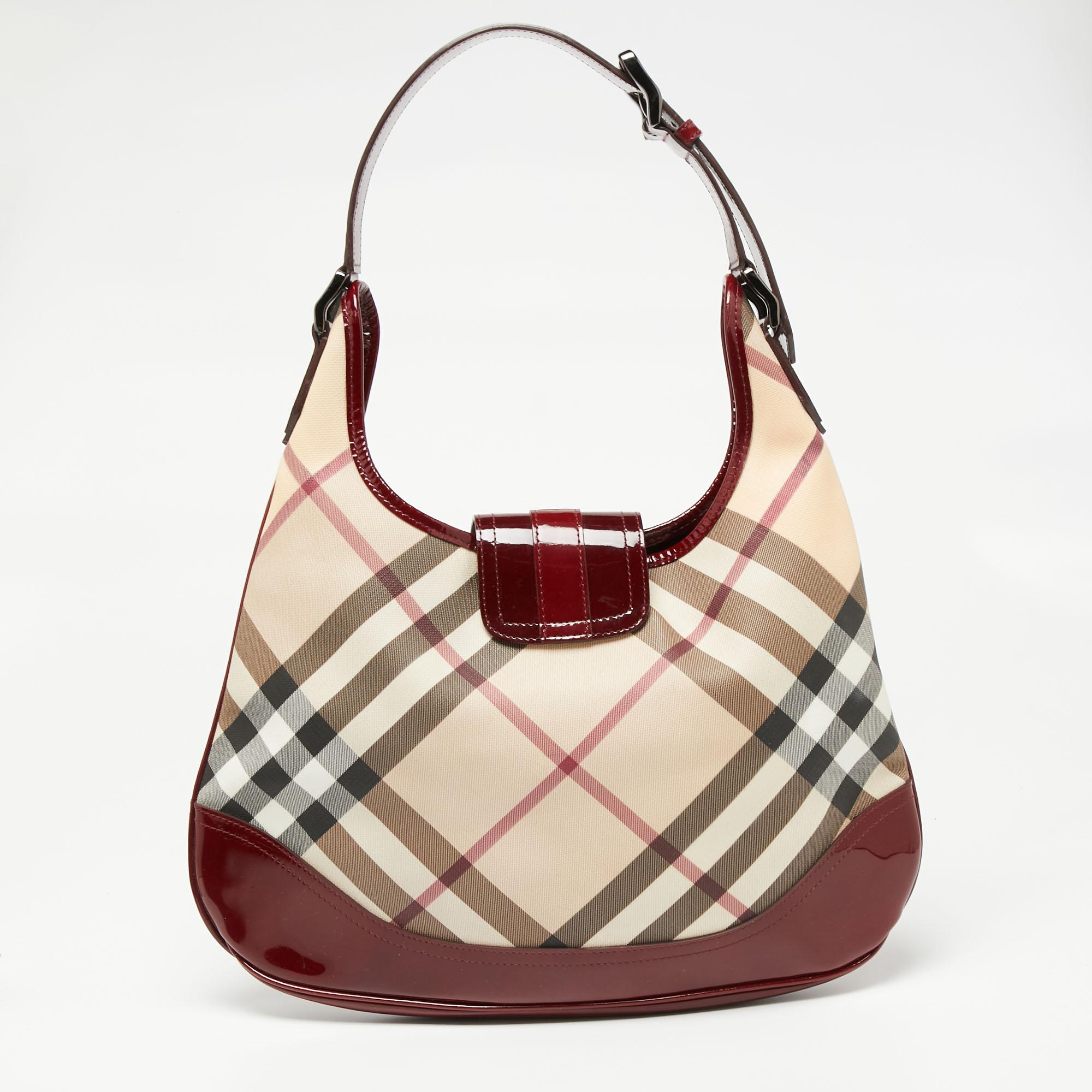 This beautifully stitched hobo in Nova Check PVC and patent leather is by Burberry. With a capacious fabric-lined interior, a comfortable handle, and a fine finish, this hobo is bound to offer style and practical ease.

Includes: Info card