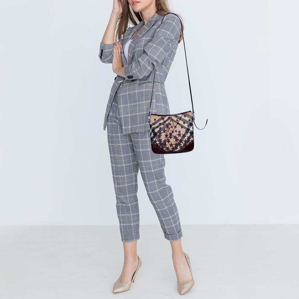 This adorable and classic crossbody bag features a signature Supernova check coated canvas body accented with patent leather trims and a starry print. Black-tone hardware makes this bag luxurious and the interior offers just enough space for all of