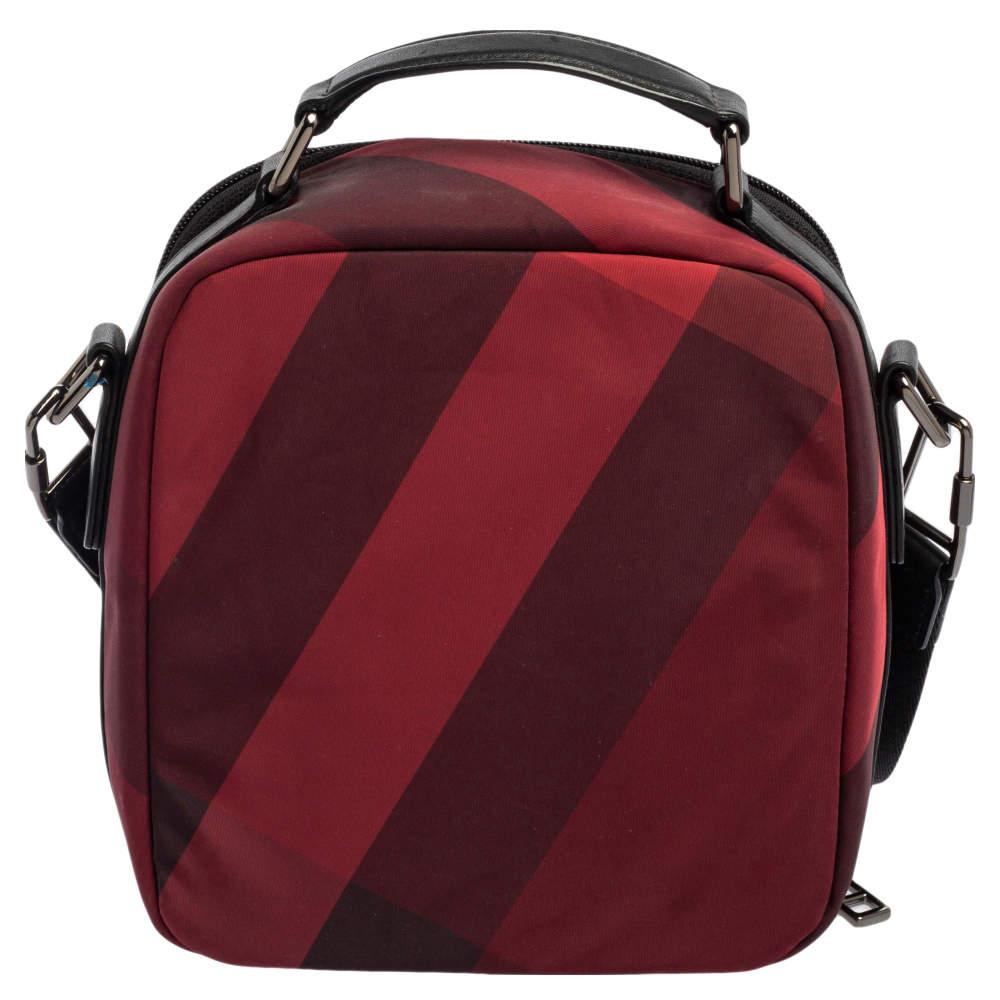 This messenger bag from Burberry is stylish and functional. Crafted from Check nylon and leather, the bag features an adjustable shoulder strap, a top handle, and a fabric-lined main interior.

Includes: Info Booklet