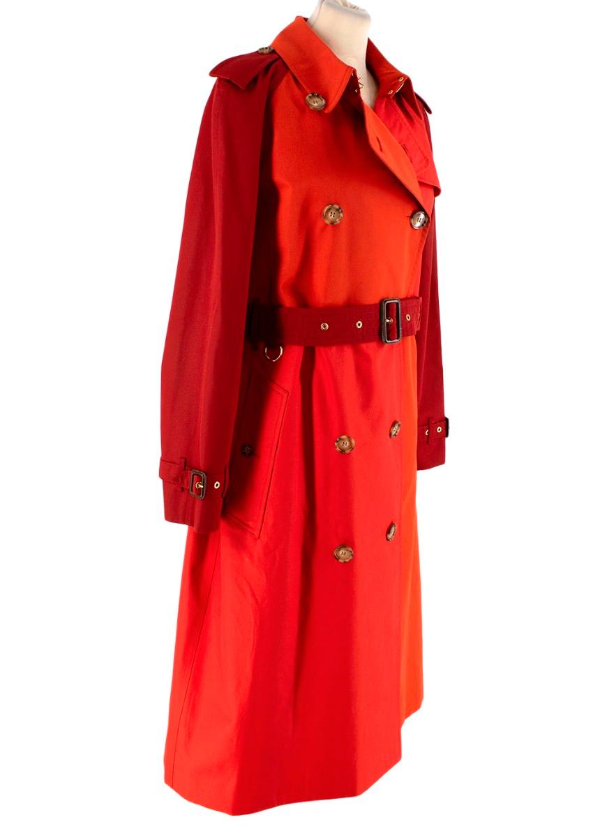 Burberry Red & Burgundy Long Garbardine Trench Coat
 

 - Bright red body with contrasting dark burgundy sleeves 
 - Double breasted 
 - Burgundy buckle belt
 - All signature trench details, including storm cape, epaulettes & gun flap
 - Fully lined