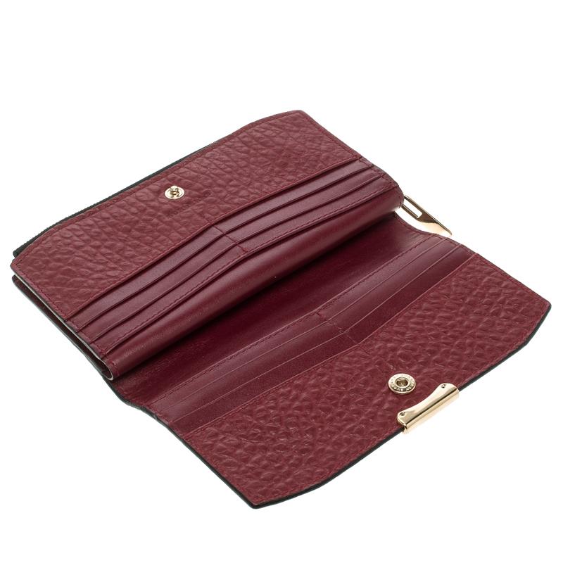 From the luxury label, Burberry, comes this well-crafted wallet that is, fair to say, designed with perfection. It has been made from check-embossed leather and styled with a zip compartment and a snap button which reveals multiple slots. It is