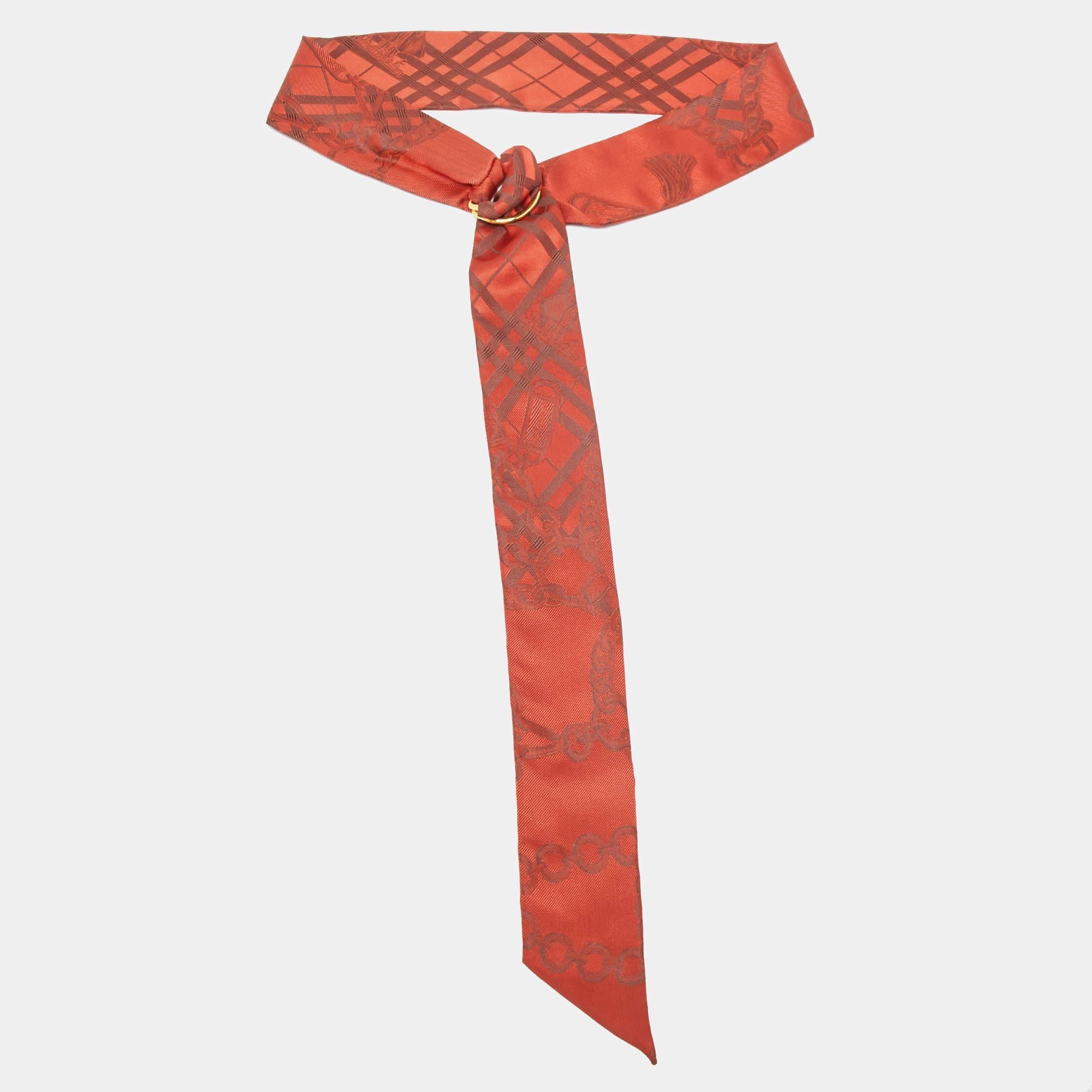 The Burberry scarf features a luxurious silk jacquard fabric adorned with a classic chain pattern. Its vibrant red hue adds a touch of sophistication  while the D ring detail offers versatile styling options. Perfect for adding a refined and elegant