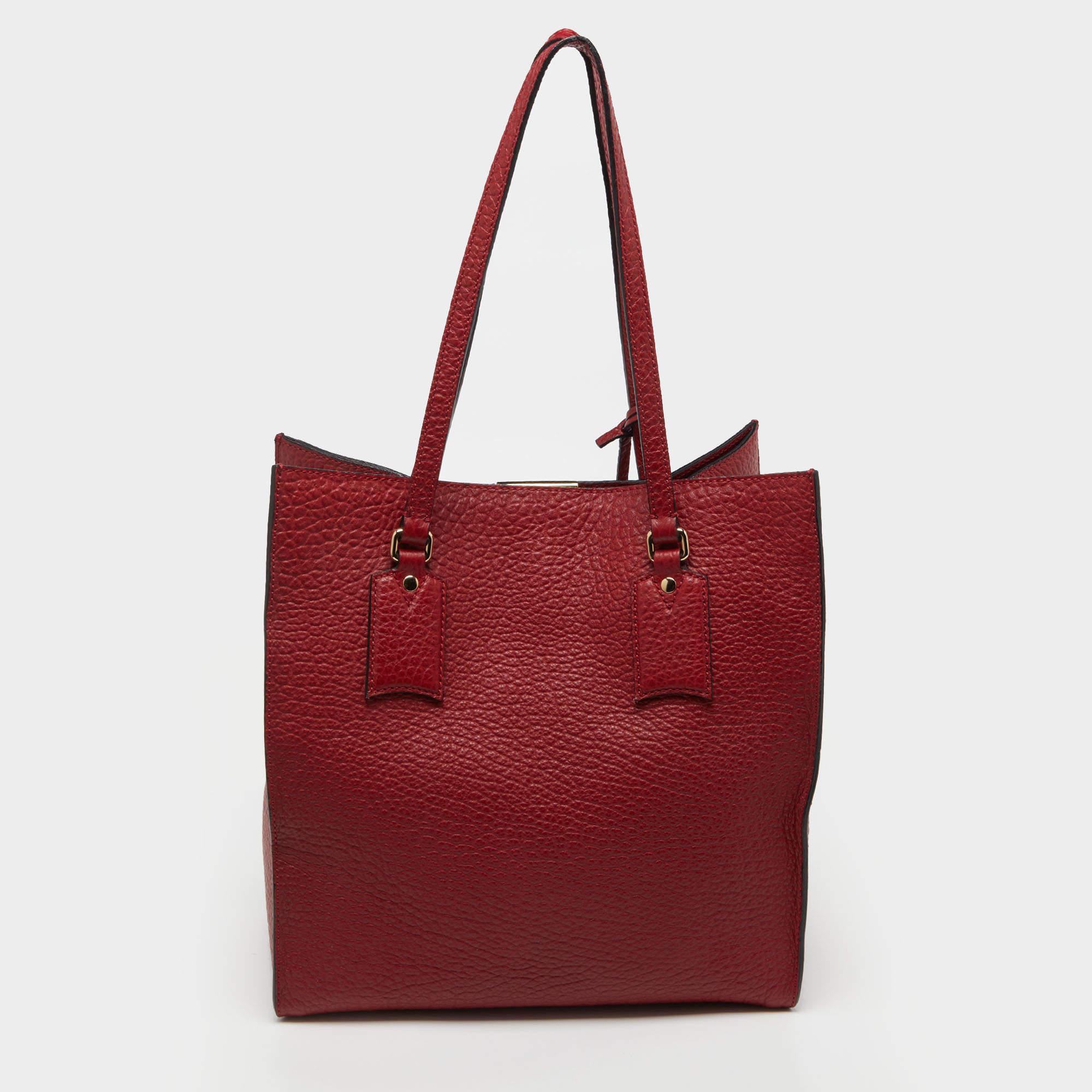 Indulge in timeless luxury with this Burberry red bag. Meticulously handcrafted, this iconic piece combines heritage, elegance, and craftsmanship, elevating your style to a level of unmatched sophistication.

