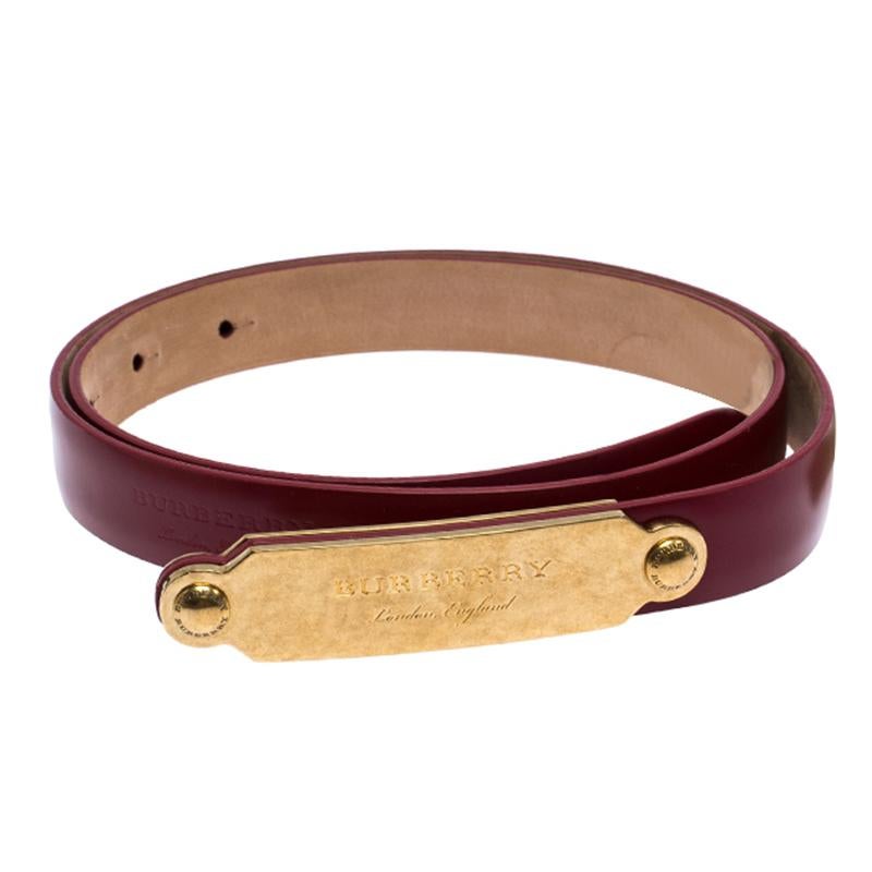 Elevate your belt collection by adding this buckle belt from Burberry. Crafted from red leather, the piece is complete with a gold-tone buckle detailed with the brand name. The sophisticated belt can be styled with various outfits.

Includes: