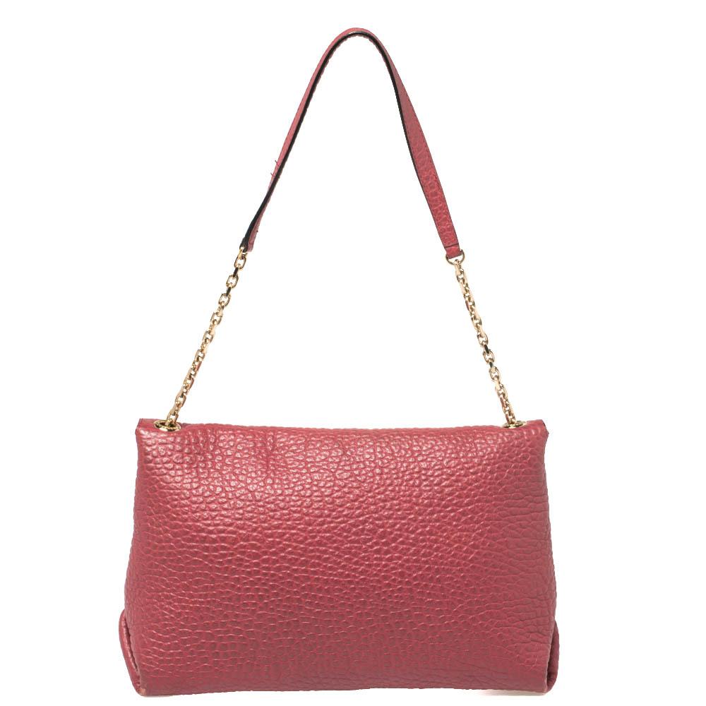 Masterfully crafted in pebbled leather, this bag by Burberry can easily hold more than just essentials. It comes in a striking red color and features a front flap that opens to a fabric-lined interior. it is equipped with gold-tone hardware and a