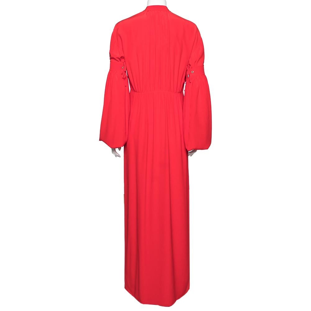 With its eye-catchy hue and chic design, this dress from the House of Burberry will surely make you the star of any event. It is tailored using red silk fabric into a flowy maxi-length silhouette. It has a button-down feature, multiple tie details