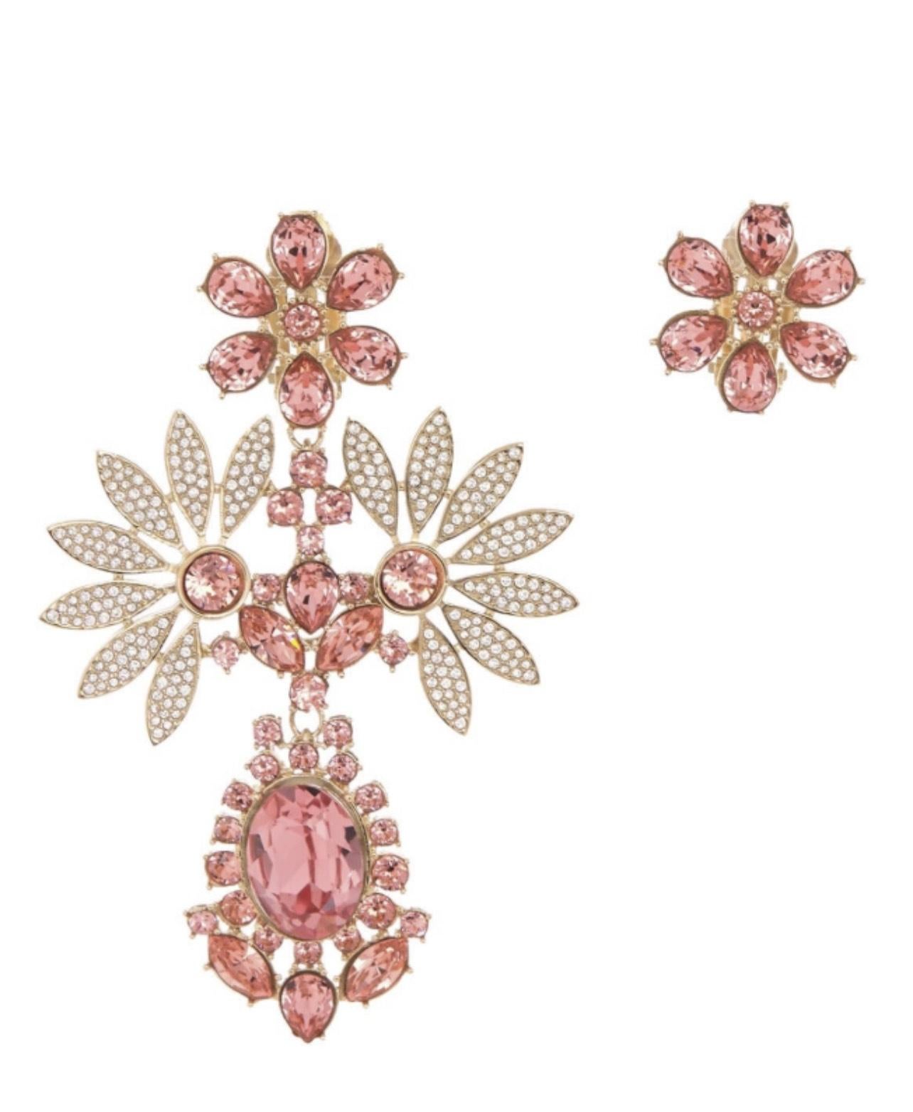 Burberry Ladies Earrings. Coral Pink. Burberry Rhinestone Flower Mismatched Cocktail Earrings in Coral Pink. Rhinestone embellished floral mismatched cocktail earrings and features post back.