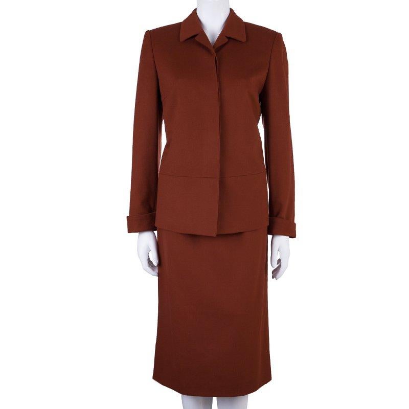 Colored with a stately red shade, this Burberry skirt suit will keep your confidence high and soaring. Made from wool and cashmere blend, this suit features a classic straight cut skirt with a back zip fastening. Topping it off is the perfect