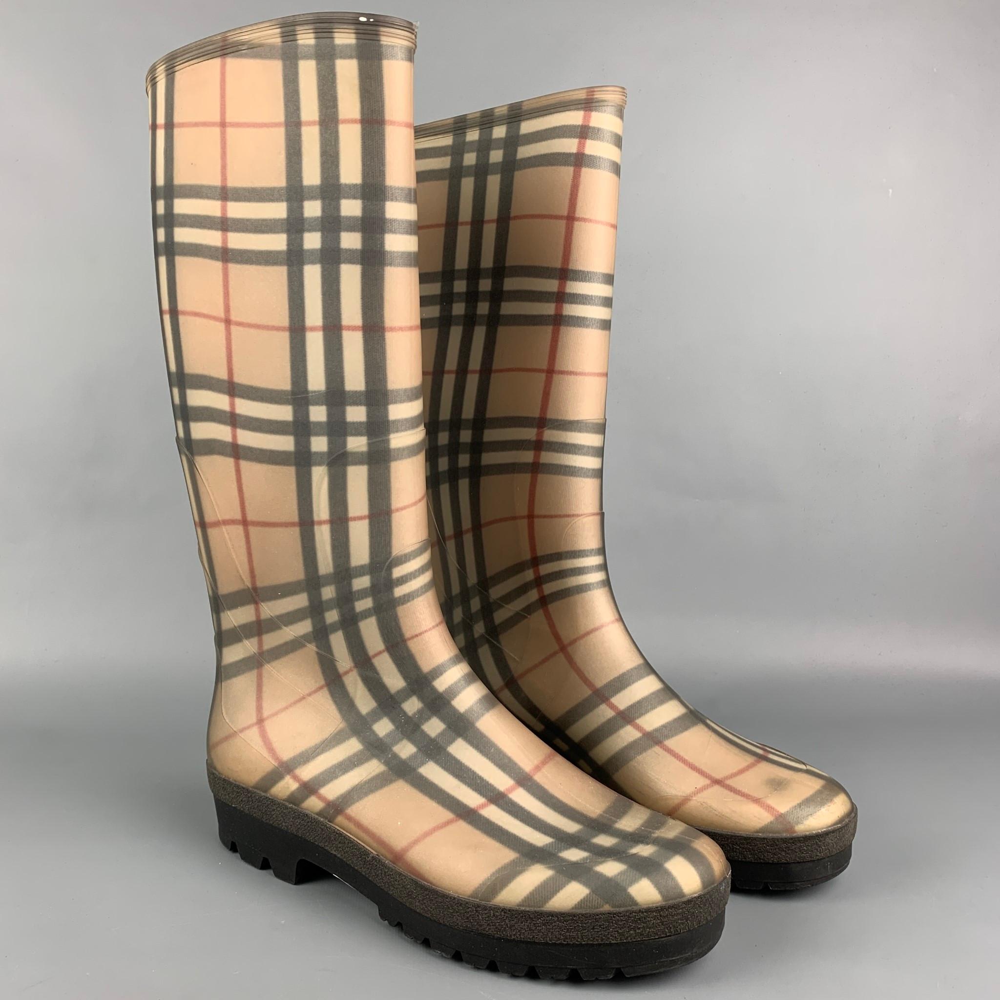BURBERRY rain boots comes in a beige & black plaid rubber, mid calf, and a chunky heel. 

Good Pre-Owned Condition.
Marked: 43/9
Original Retail Price: $490.00

Measurements:

Length: 11.25 in.
Width: 4 in.
Height: 14.5 in. 