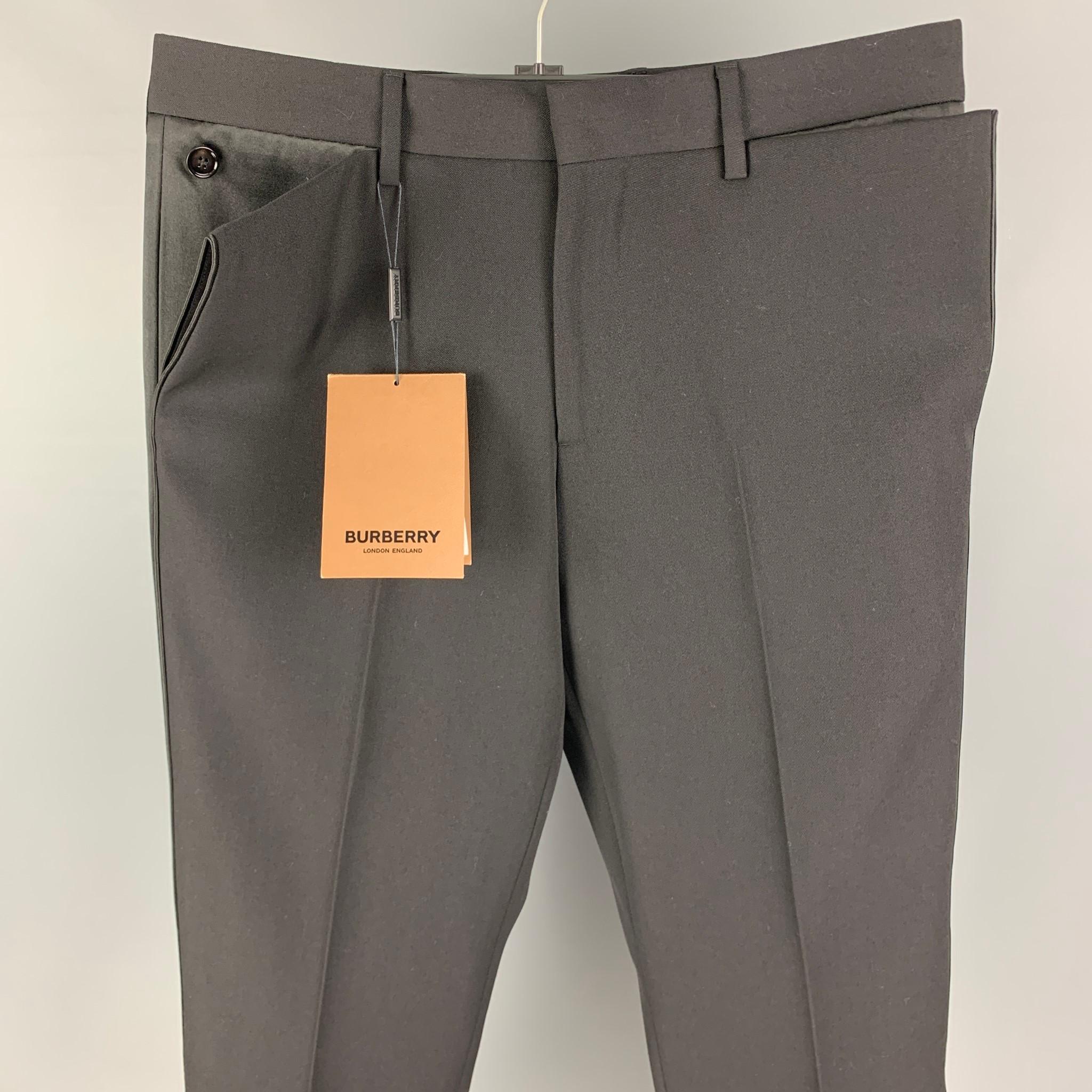 BURBERRY dress pants comes in a black wool featuring a flat front, buttoned details, front tab, and a zip fly closure. Made in Italy. 

New with tags.
Marked: 48
Original Retail Price: $990.00

Measurements:

Waist: 32 in.
Rise: 10 in.
Inseam: 32