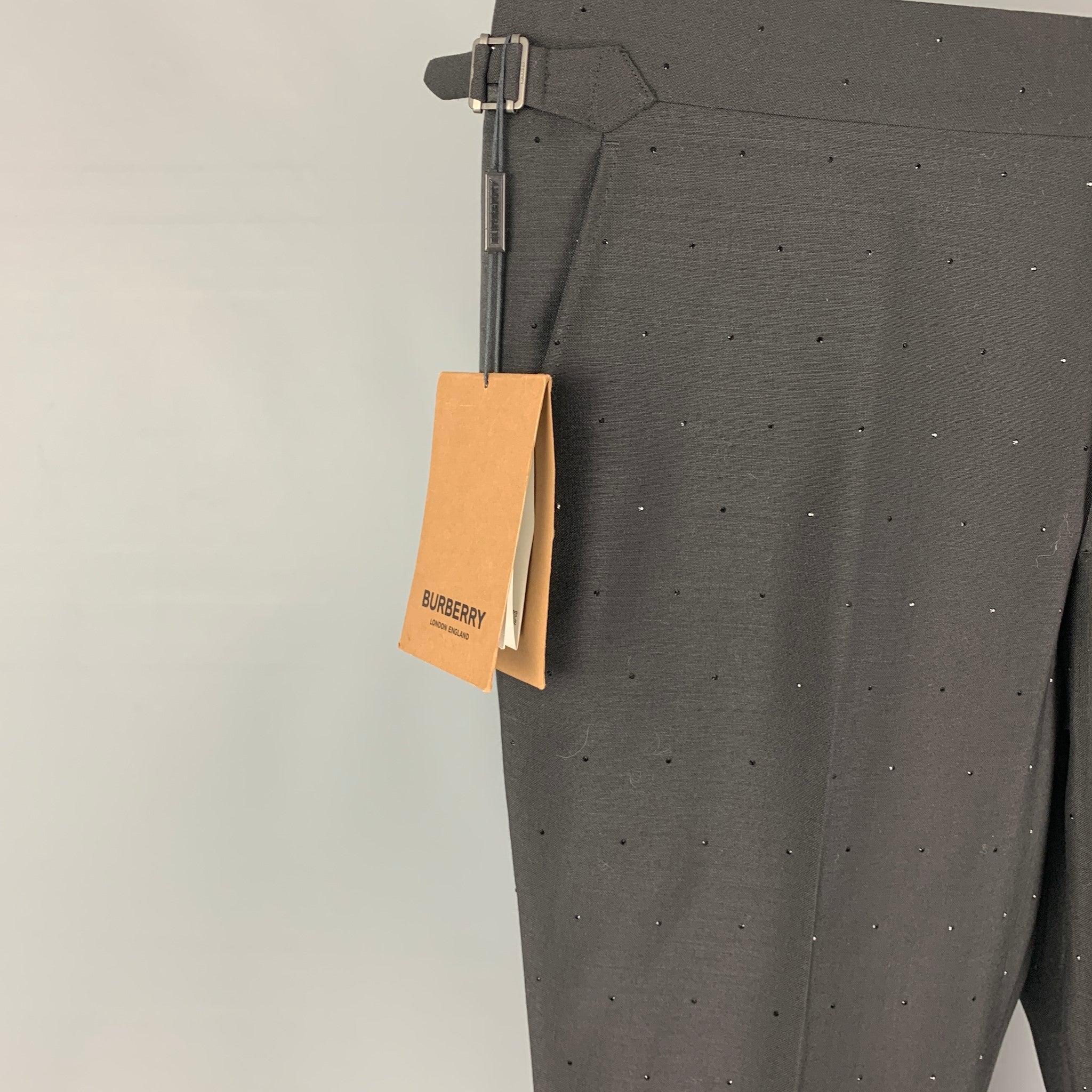 BUBERRY dress pants comes in a black mohair / wool with embellished details featuring a flat front, adjustable side tabs, and a zi fly closure. Made in Italy.New with tags.
 

Marked:  52 R 

Measurements: 
 Waist: 36 inches Rise:
11 inches Inseam: