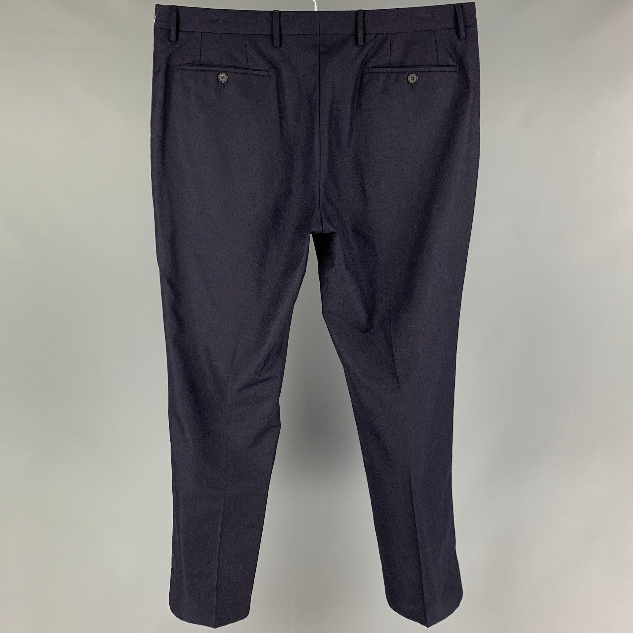 BURBERRY dress pants comes in a navy wool featuring a flat front, front tag, and a zip fly closure. Made in Italy.
Very Good
Pre-Owned Condition. 

Marked:  54R 

Measurements: 
 Waist: 38 inches Rise: 10 inches Inseam: 31 inches 
 
 
 
Reference: