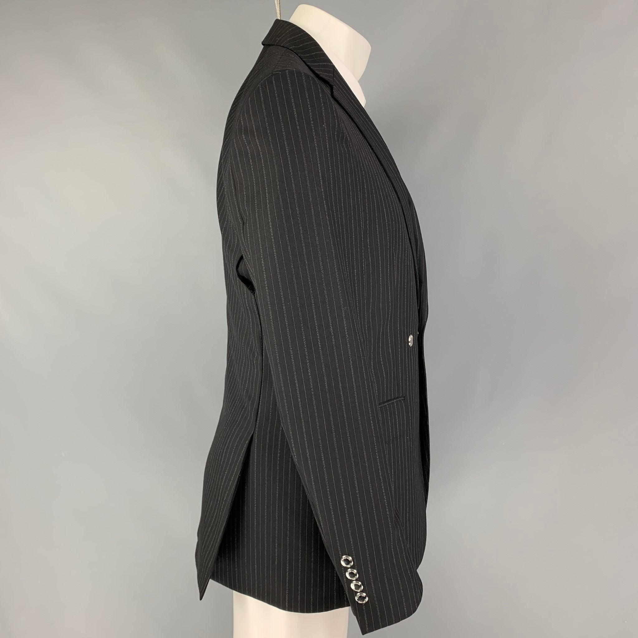 BURBERRY
sport coat comes in a black & grey stripe wool with a full liner featuring a notch lapel, flap pockets, double back vent, silver tone hardware, and a single button closure. Made in Italy. Very Good Pre-Owned Condition. Small tear at hem. 