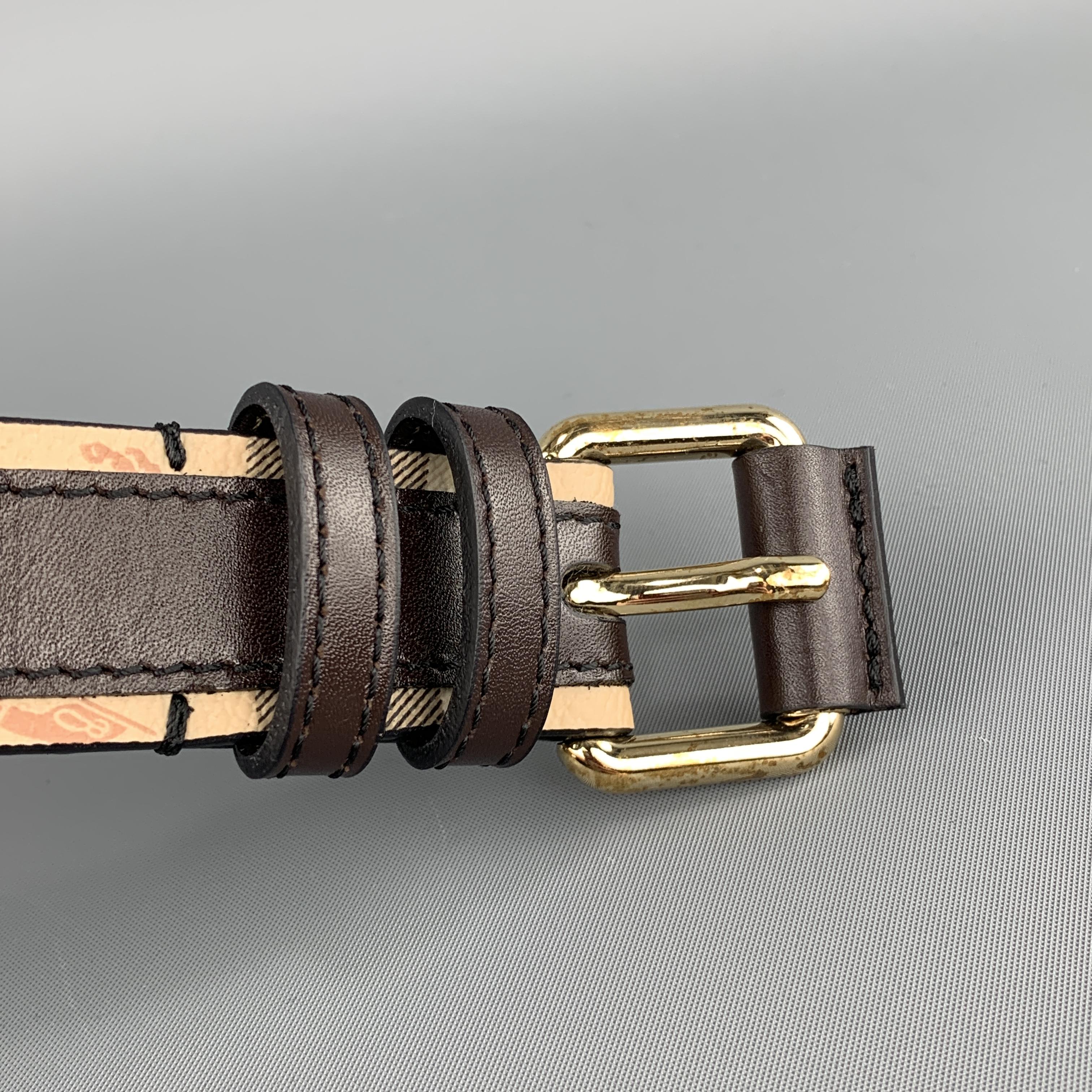 BURBERRY belt features a tan signature plaid coated canvas strap with brown leather stripe and gold tone buckle. New but wear on metal from storage. As-is. Made in Italy.
 
Brand New with Defects.
Marked: 42 / 105
 
Length: 47 in.
Width: 1 in.
Fits: