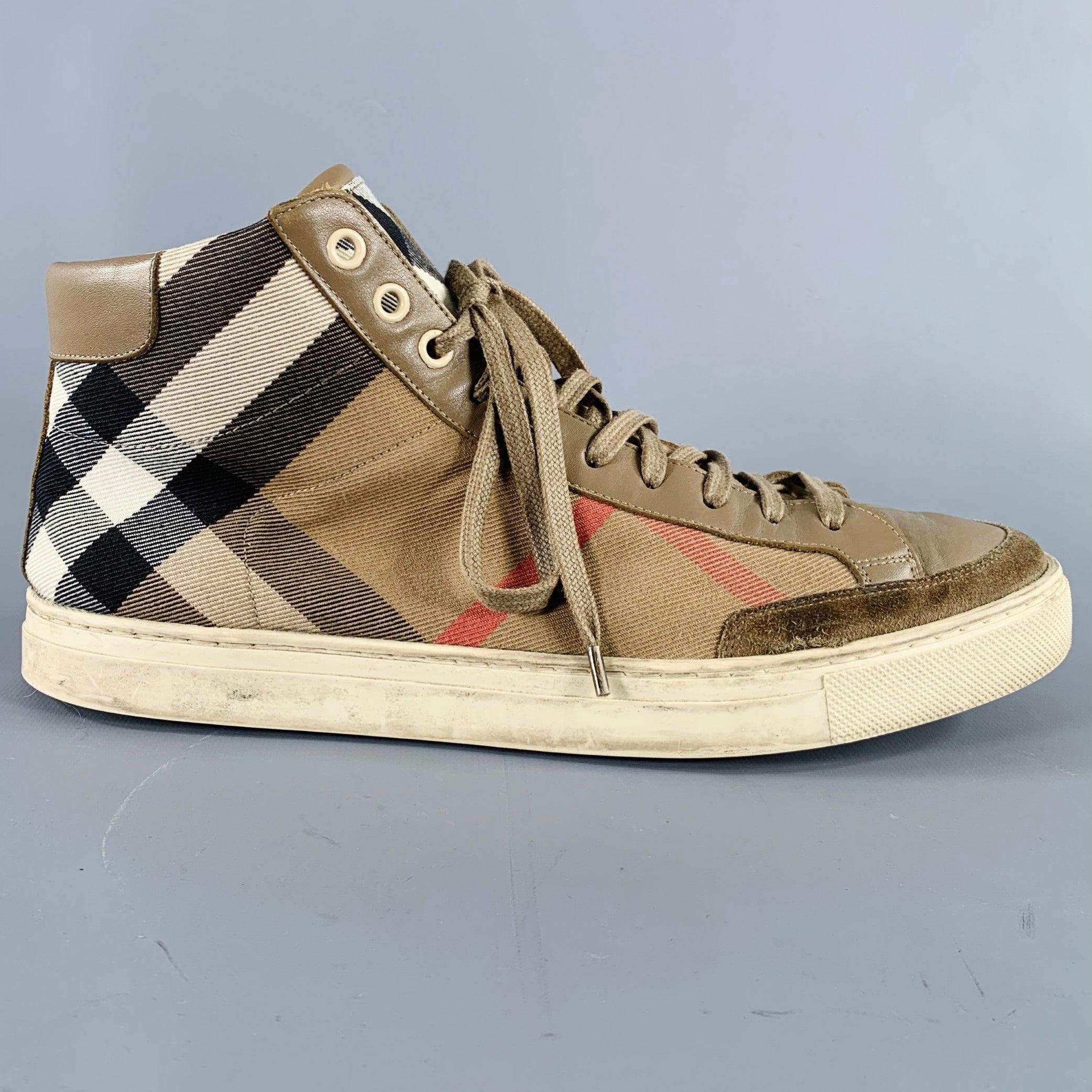 BURBERRY sneakers
in a beige and black canvas featuring signature Burberry check pattern, high top style, and lace-up closure. Made in Spainches Very Good Pre-Owned Condition. Moderate signs of wear. 

Marked:   ESSUSSHO18ELD 41Outsole: 11 inches  x