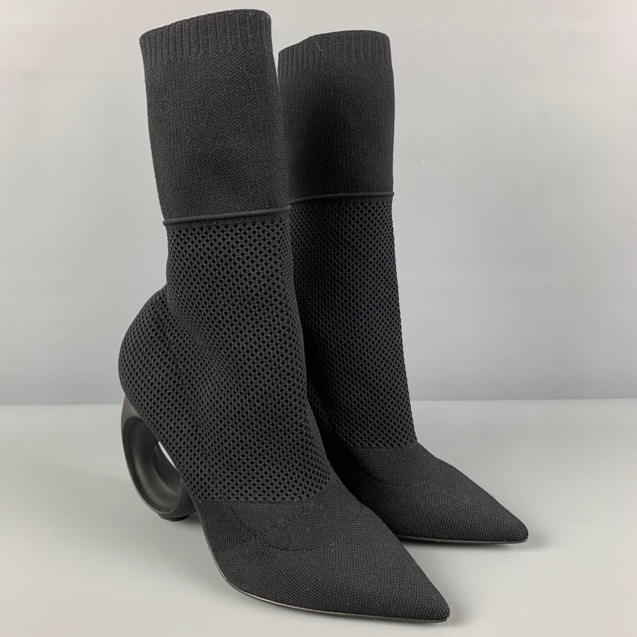 BURBERRY boots comes in a black knitted nylon featuring a slip on style, pointed toe, and a chunky circular heel design. Made in Italy. New with Tags. 

Marked:   38 

Measurements: 
  Length:
8.5 inches  Width: 3.25 inches  Height:
9 inches  Heel: