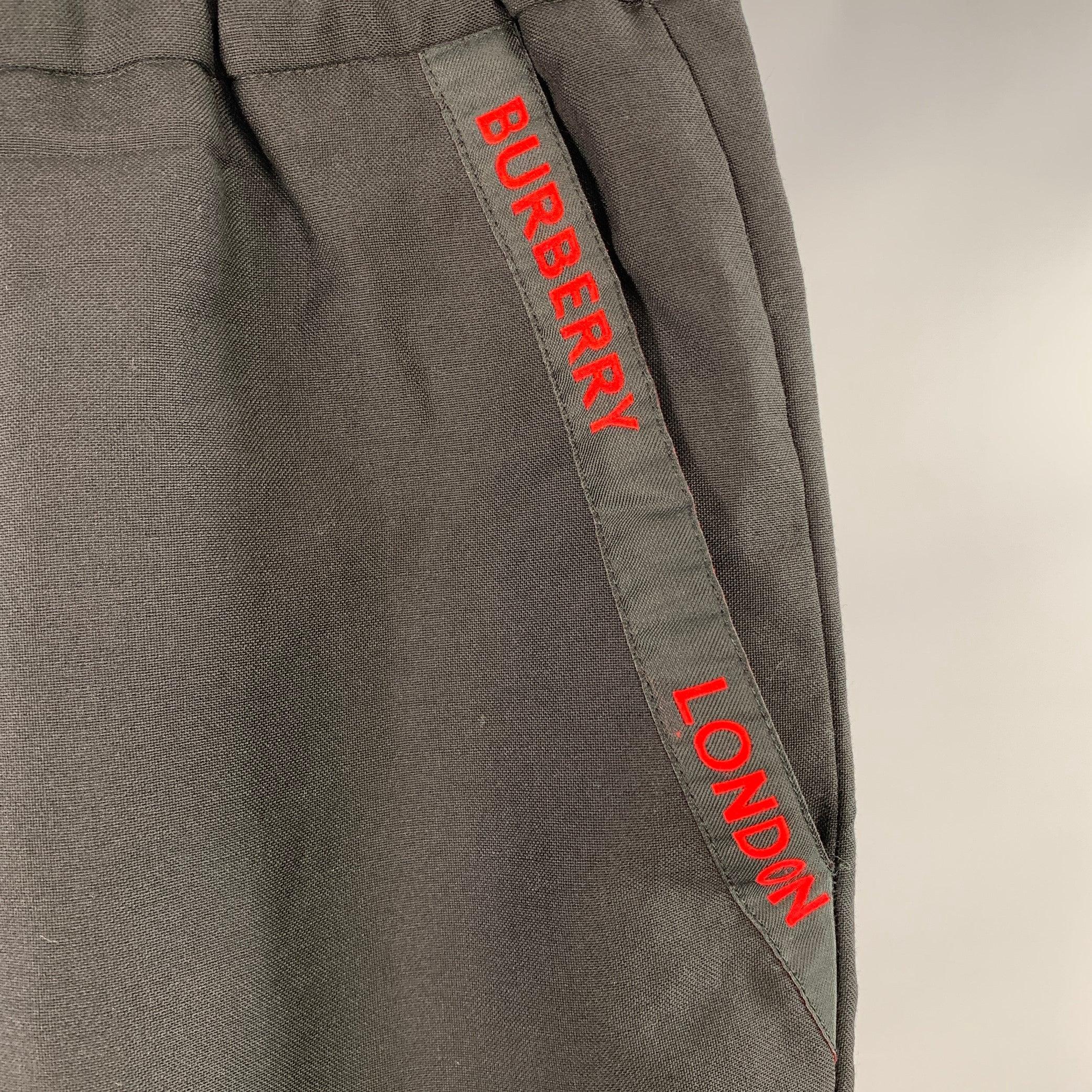 BURBERRY casual pants
in a black wool mohair blend fabric featuring red logo pocket trim, tapered leg, and elastic waistband. Made in Italy.Excellent Pre-Owned Condition. 

Marked:   IT 54 

Measurements: 
  Waist: 34 - 38 inches Rise: 10.5 inches