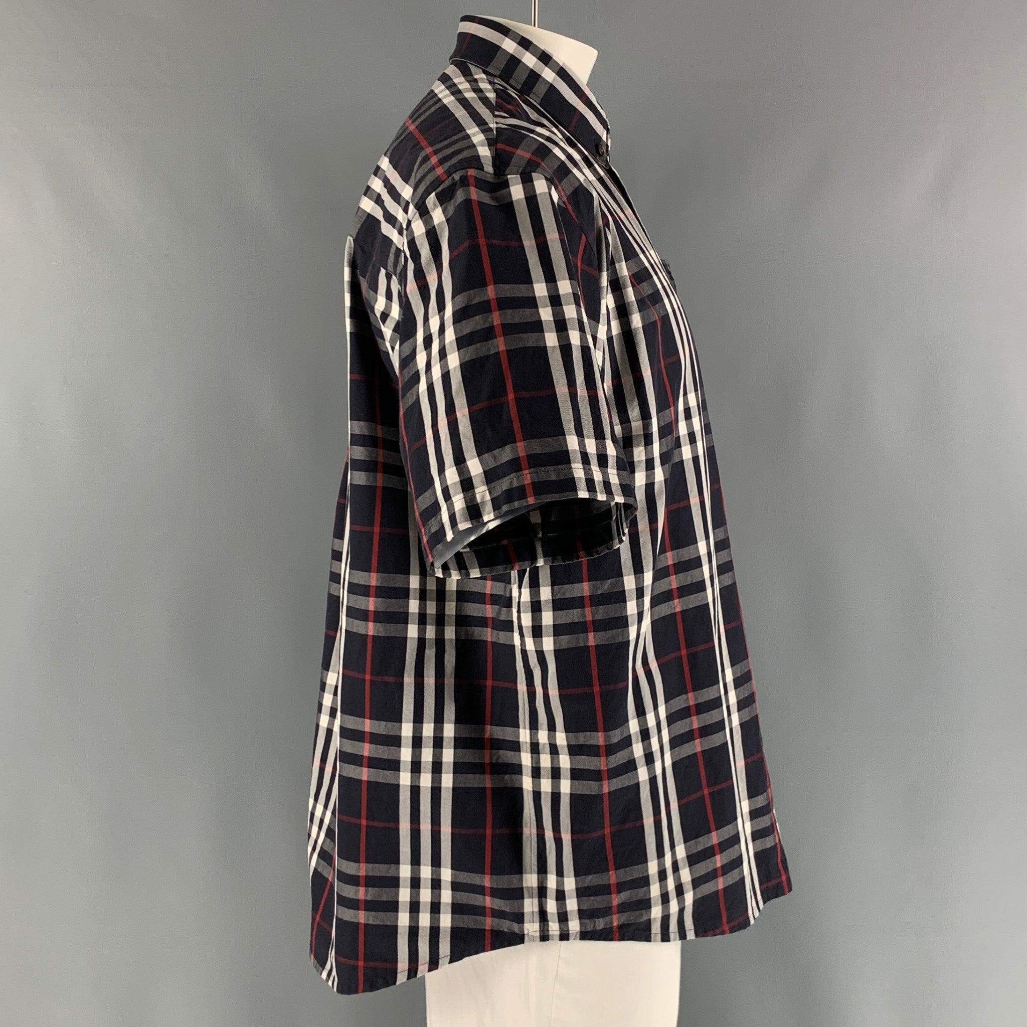 BURBERRY short sleeve shirt comes in a navy, white and red plaid cotton twill material featuring a button down collar, and a button up closure. Made in Italy. Excellent Pre-Owned Condition. 

Marked:   L 

Measurements: 
 
Shoulder: 22 inches Chest: