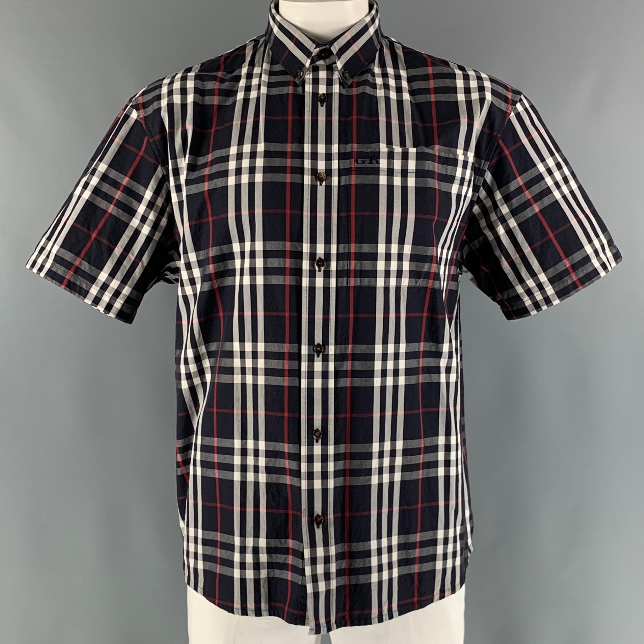 BURBERRY short sleeve shirt comes in a navy, white and red plaid cotton twill material featuring a button down collar, and a button up closure. Made in Italy.

Excellent Pre-Owned Condition.
Marked: L

Measurements:

Shoulder: 22 in.
Chest: 50